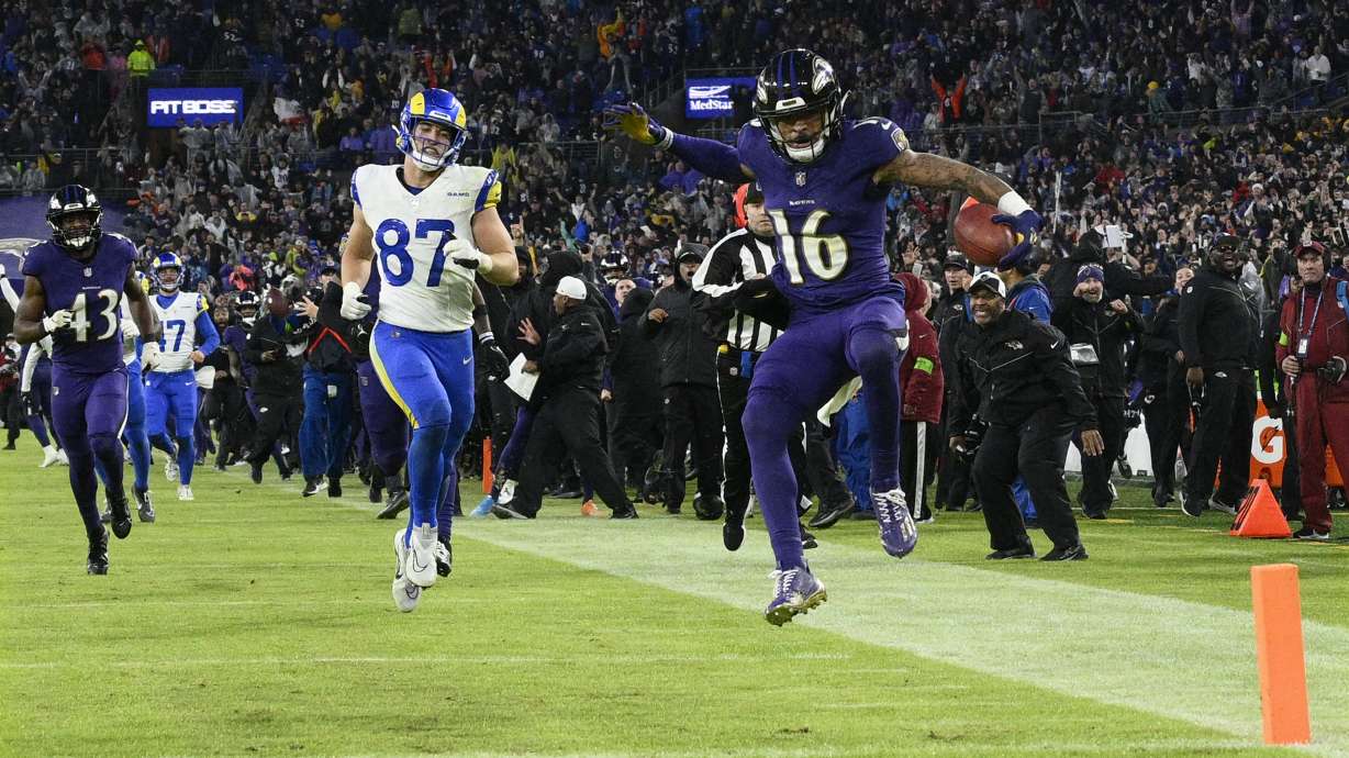 Baltimore Ravens punt returner Tylan Wallace (16) starts to celebrates as he returns a punt for a game-winning touchdown as Los Angeles Rams tight end Davis Allen (87) looks on during overtime of an NFL football game Sunday, Dec. 10, 2023, in Baltimore. The Ravens won 37-31.