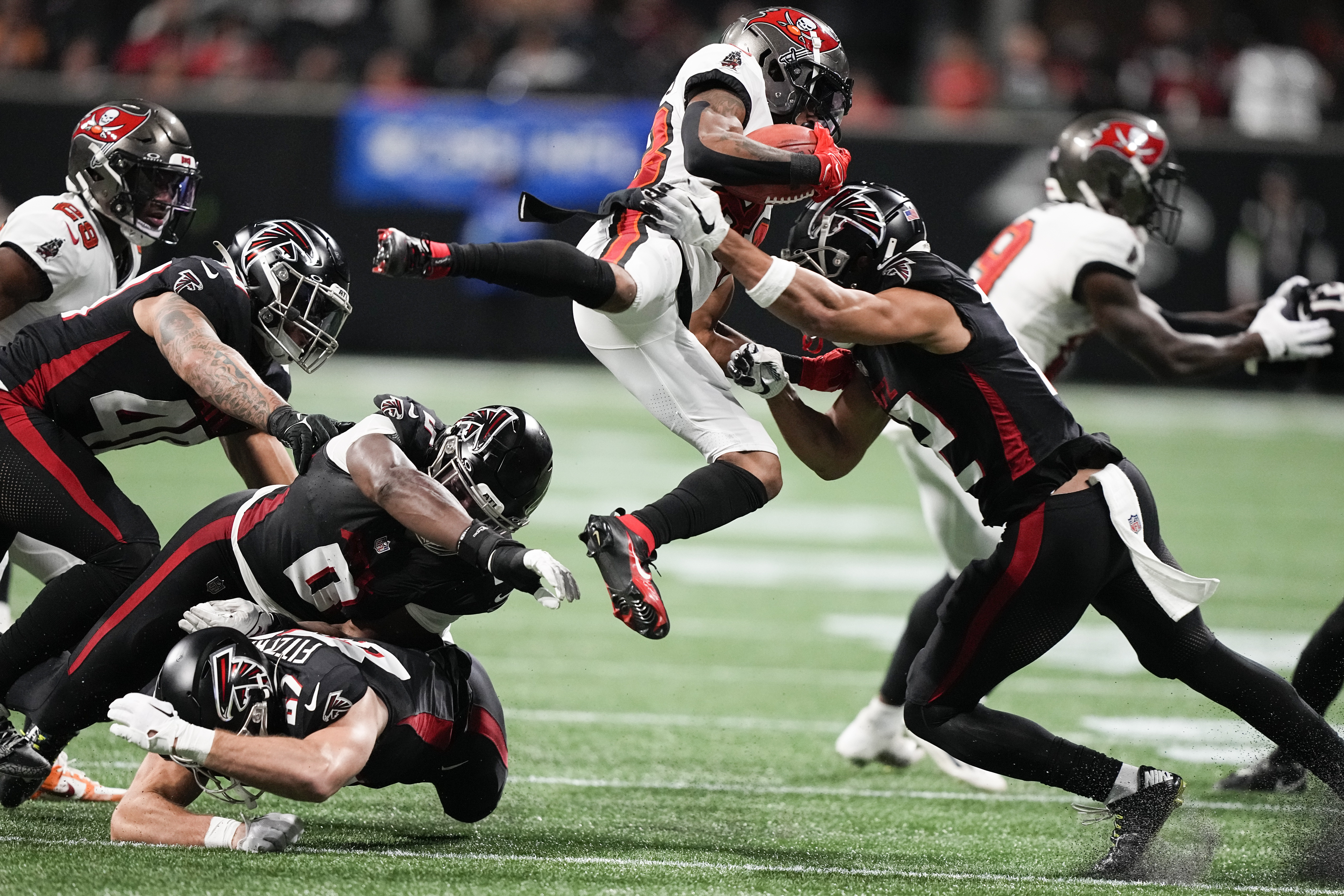 Tampa Bay Buccaneers wide receiver Deven Thompkins (83) is stopped by Atlanta Falcons wide receiver KhaDarel Hodge (12) during the second half of an NFL football game, Sunday, Dec. 10, 2023, in Atlanta.