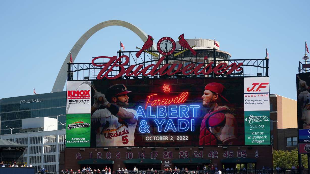 File - a video screen is seen in Busch Stadium as St. Louis Cardinals' Albert Pujols (5) and Yadier Molina (4) are honored during a ceremony before the start of the Cardinals' final regular season baseball game Sunday, Oct. 2, 2022, against the Pittsburgh Pirates in St. Louis. The Cardinals and the world’s leading brewer, Anheuser-Busch, announced, Wednesday, Dec. 13, 2023 that the two historic St. Louis institutions have agreed to a five-year extension of their long-term marketing agreement through 2030.