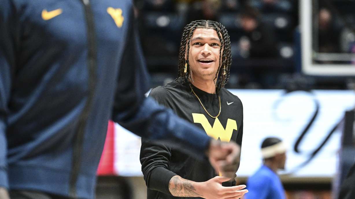 West Virginia Guard RaeQuan Battle looks on prior to the game against the Pittsburgh Panthers on Dec. 6, 2023, in Morgantown, WV. Battle, formerly of Montana State, has yet to play this season. College athletes like Battle who were denied the chance to play immediately after transferring a second time can return to competition, for now, after a federal judge issued a 14-day temporary restraining order Wednesday, Dec. 13, 2023, against the NCAA.
