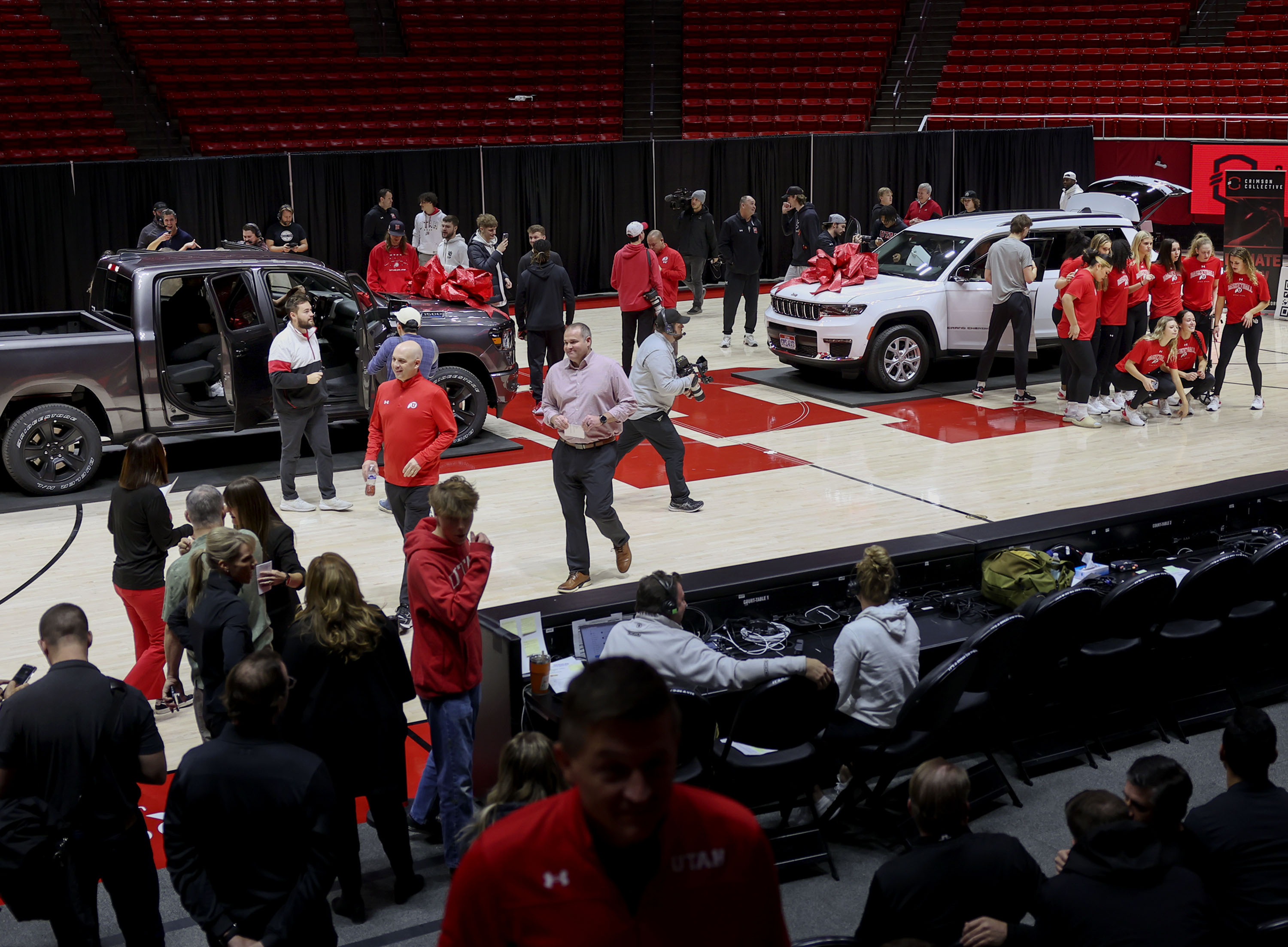 Members of the women’s gymnastics and men’s and women’s basketball programs look at 2024 Ram 1500 Big Horn Night Edition and a 2024 Jeep Grand Cherokee L Limited Edition at the Huntsman Center in Salt Lake City on Wednesday, Dec. 13, 2023. A vehicle lease deal was made available to the athletes as part of a name, image and likeness package.
