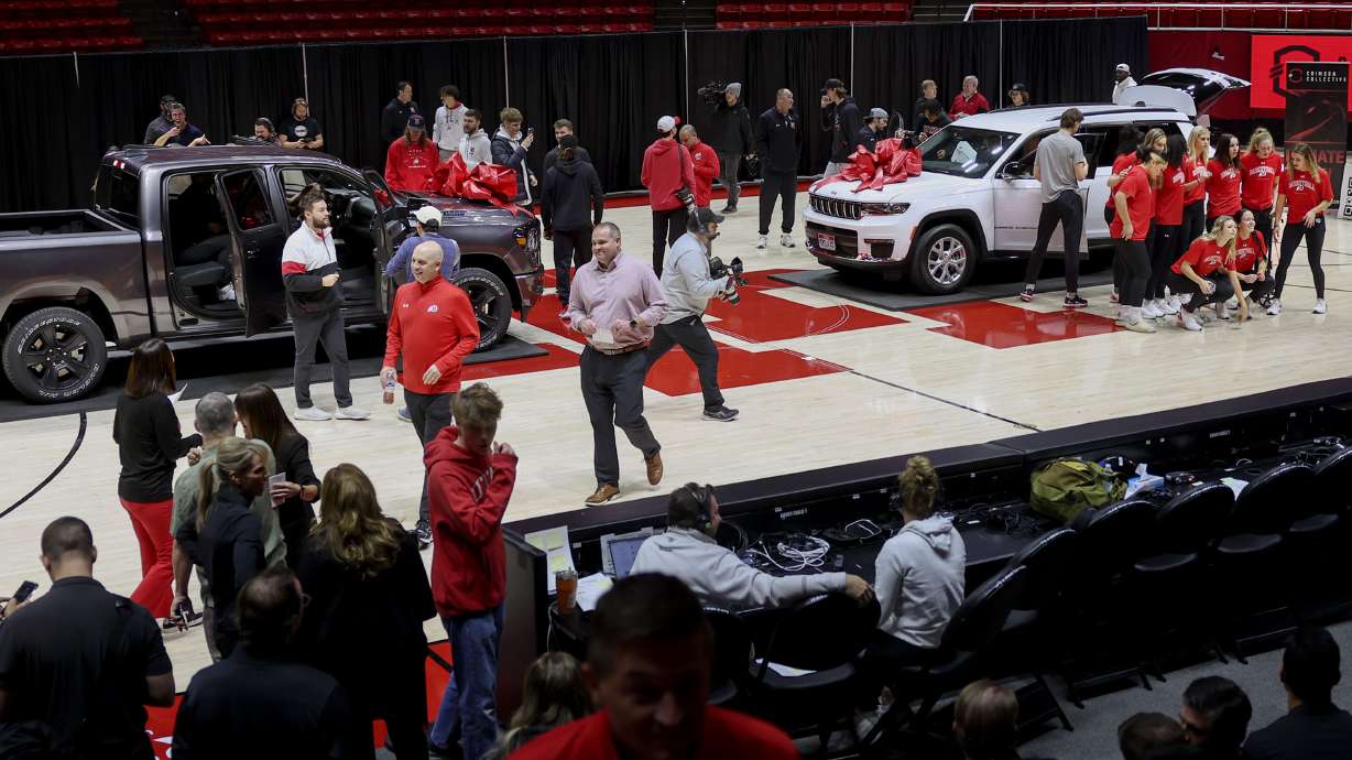 Members of the women’s gymnastics and men’s and women’s basketball programs look at 2024 Ram 1500 Big Horn Night Edition and a 2024 Jeep Grand Cherokee L Limited Edition at the Huntsman Center in Salt Lake City on Wednesday, Dec. 13, 2023. A vehicle lease deal was made available to the athletes as part of a name, image and likeness package.