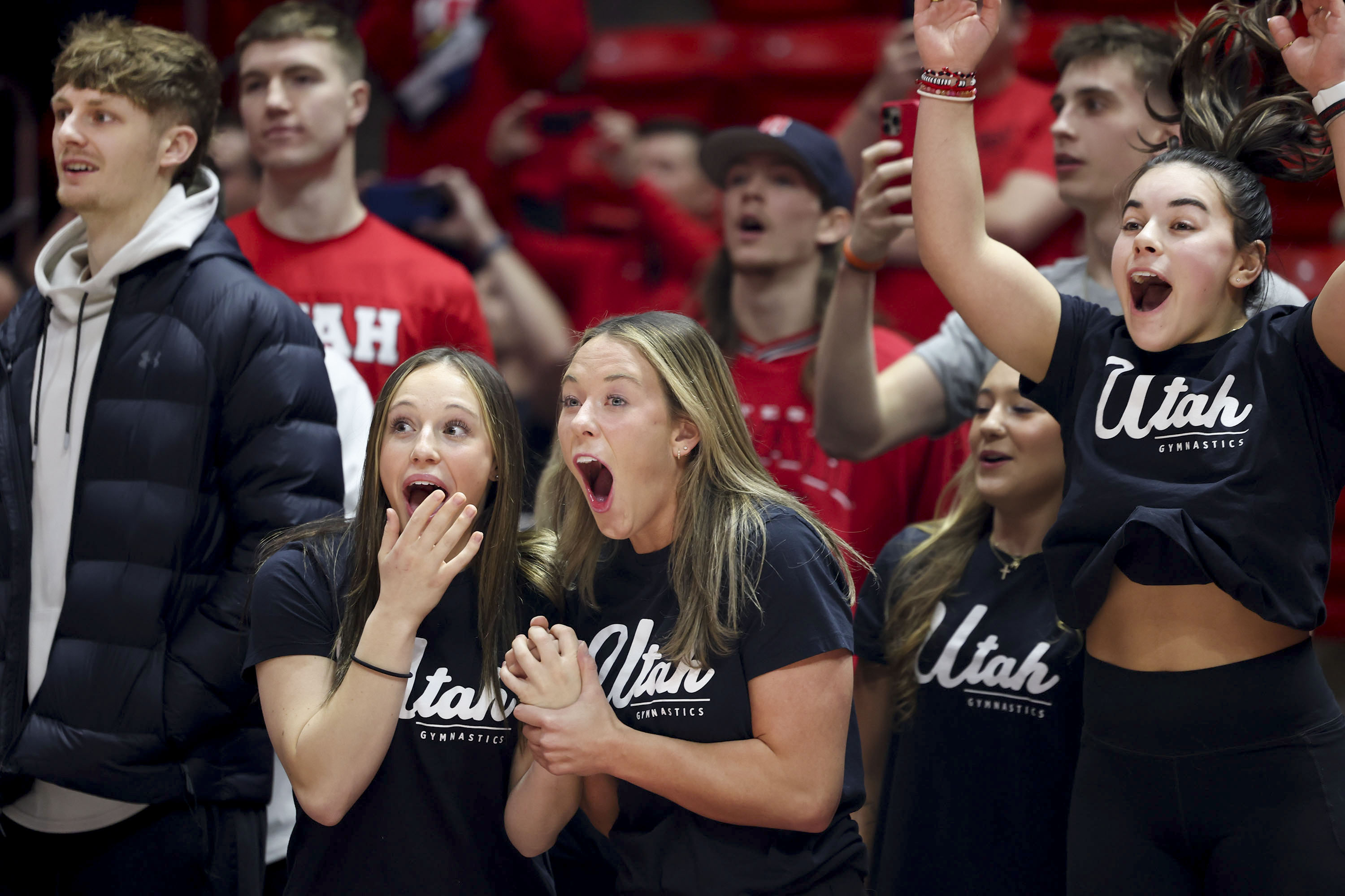 Utah men’s basketball player Cole Bajema, and gymnasts Ella Zirbes, Jaylene Gilstrap and Sarah Krump react to the announcement of a vehicle lease deal for members of the women’s gymnastics and men’s and women’s basketball programs as part of a name, image and likeness package at the Huntsman Center in Salt Lake City on Wednesday, Dec. 13, 2023.