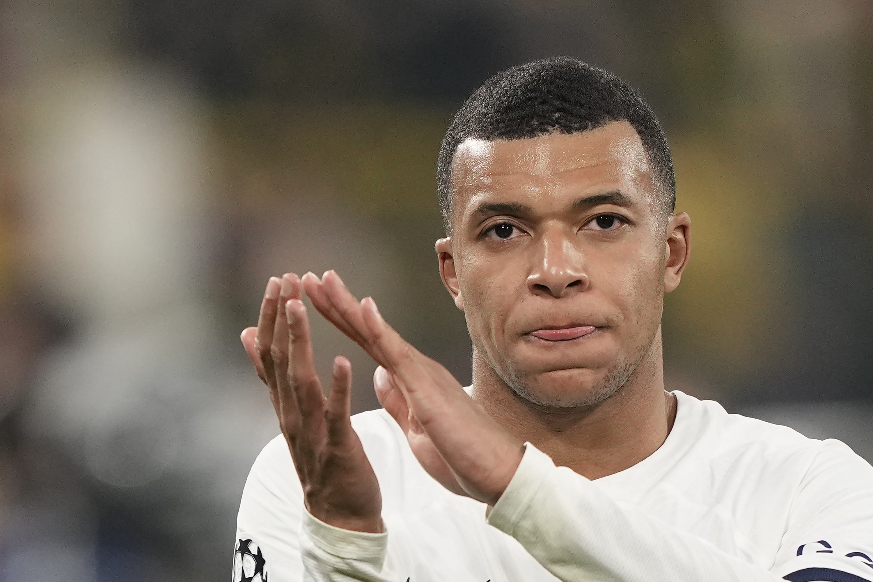 PSG's Kylian Mbappe applauds after the Champions League Group F soccer match between Borussia Dortmund and Paris Saint-Germain at the Signal Iduna Park in Dortmund, Germany, Wednesday, Dec. 13, 2023.