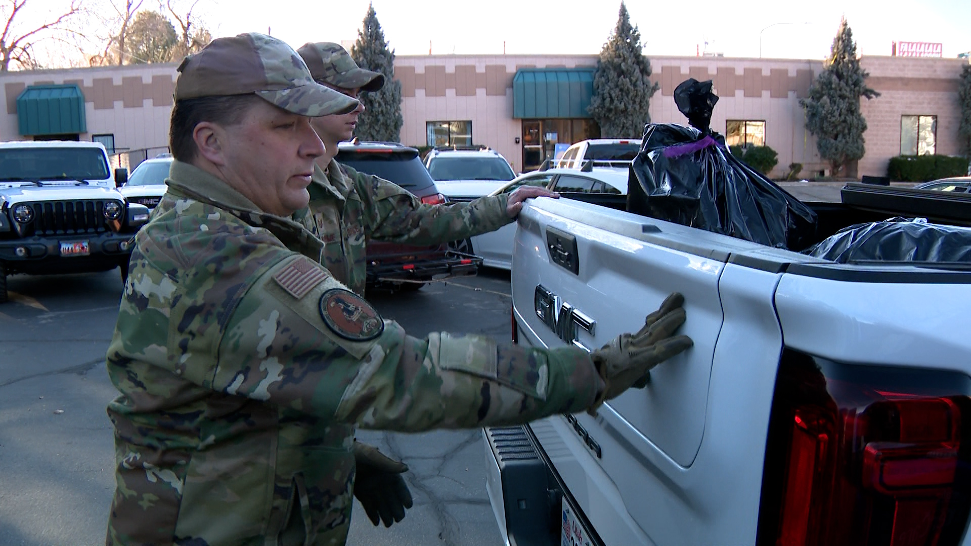 Master Sergeant Mikael Cunningham loads in gifts inside a truck on Wednesday.