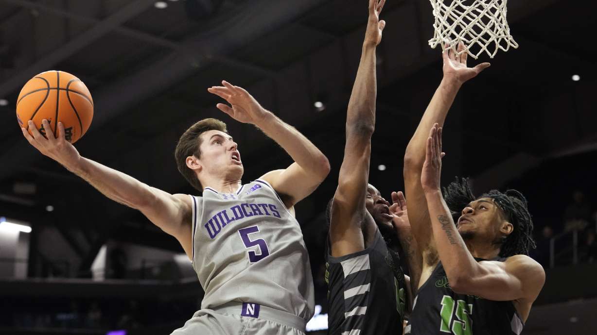 Northwestern guard Ryan Langborg, left, drives to the basket against Chicago State guard Brent Davis, center, and forward Noble Crawford during the first half of an NCAA college basketball game in Evanston, Ill., Wednesday, Dec. 13, 2023.
