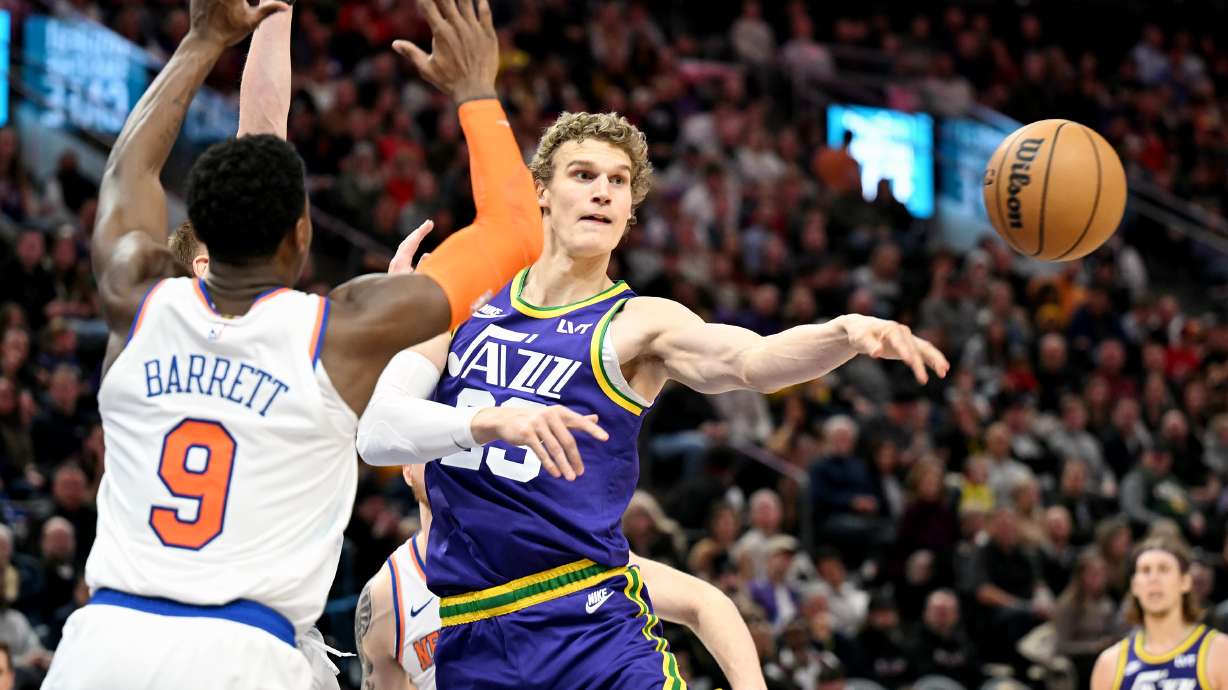 Utah Jazz forward Lauri Markkanen (23) passes the ball away as he is guarded by New York Knicks guard RJ Barrett (9) as the Utah Jazz and the New York Knicks play at the Delta Center in Salt Lake City on Wednesday, Dec. 13, 2023.