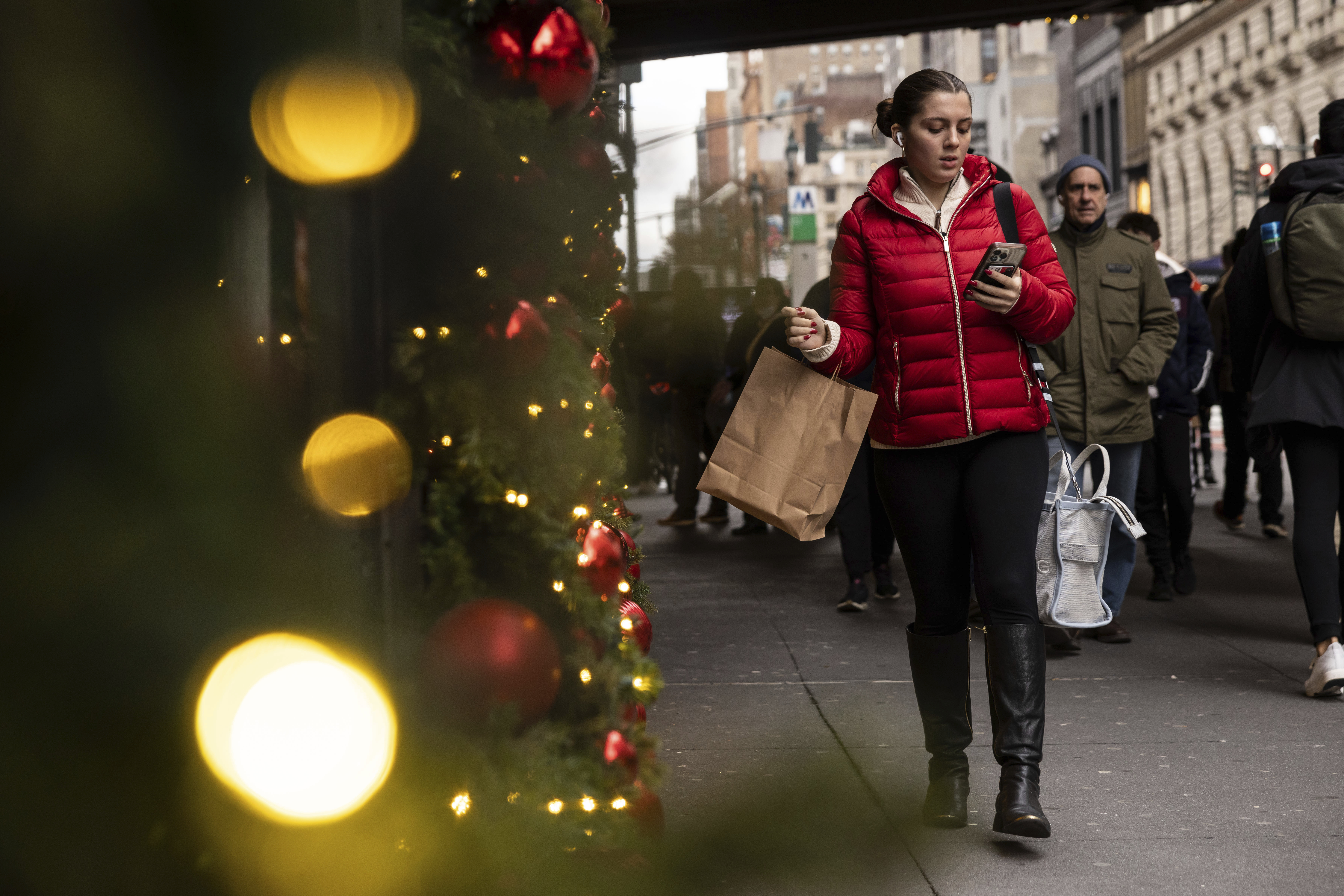 A woman passes Macy's department store in Herald Square, Dec. 11, in New York. On Thursday, the Commerce Department releases U.S. retail sales data for November. 
