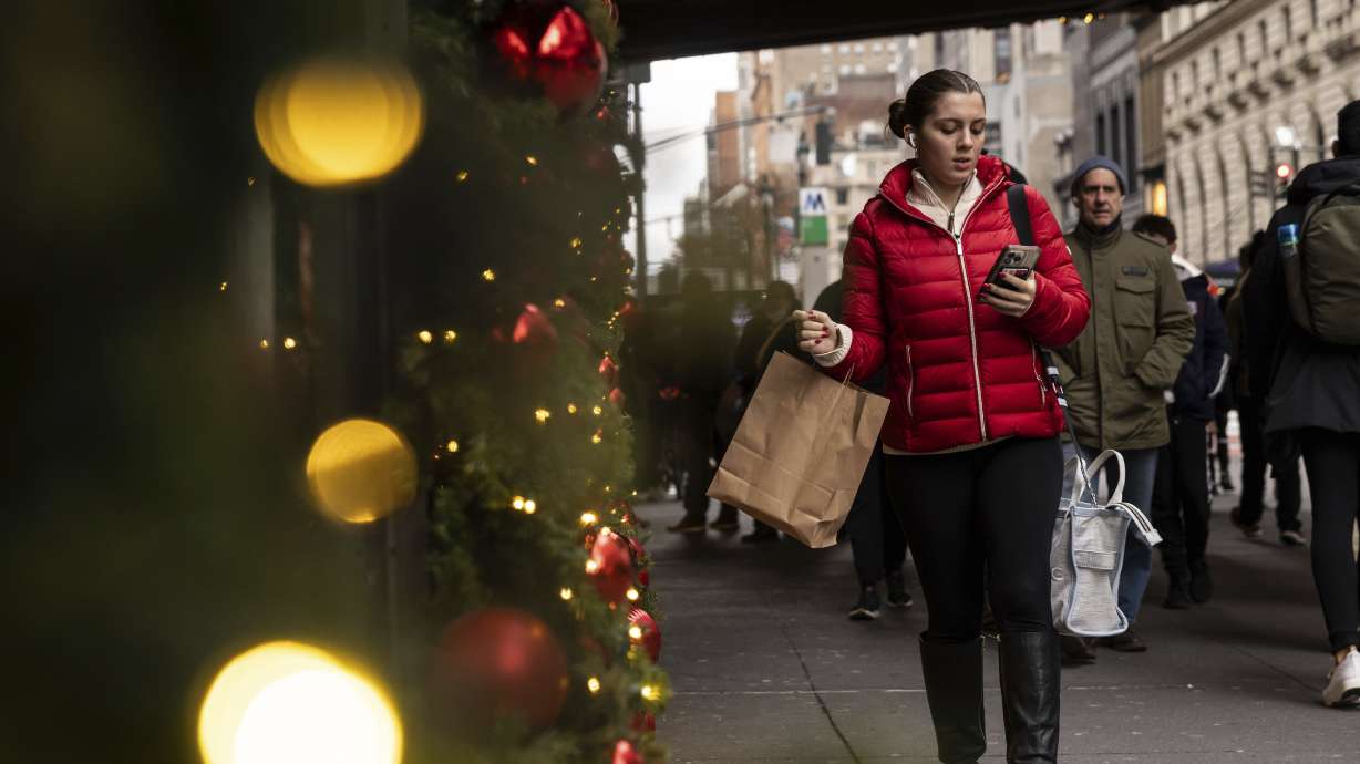 A woman passes Macy's department store in Herald Square, Dec. 11, in New York. On Thursday, the Commerce Department releases U.S. retail sales data for November.