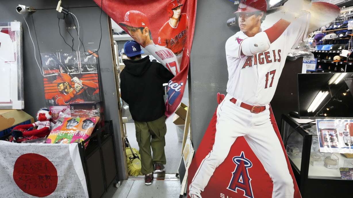 A staff member walks in his office near character goods of Shohei Ohtani of the Los Angeles Dodgers at a sporting goods store, "SELECTION," in Shinjuku district Wednesday, Dec. 13, 2023, in Tokyo. Ohtani agreed to a record $700 million, 10-year contract with the Los Angeles Dodgers.