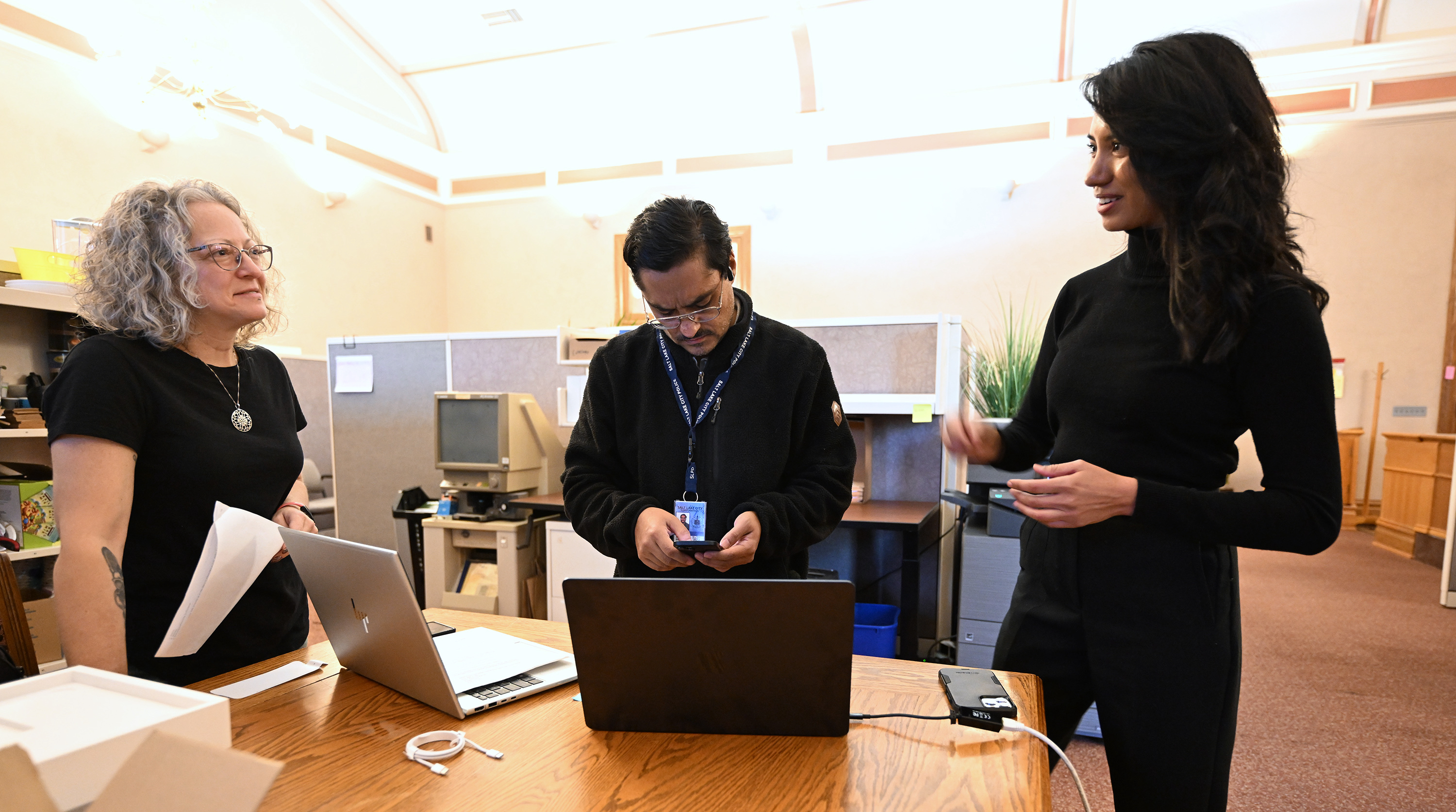 DeeDee Robinson and Toby Garcia assist Salt Lake City Councilwoman-elect Eva López Chávez set up her phone and computer at the Salt Lake City-County Building in Salt Lake City on Wednesday.