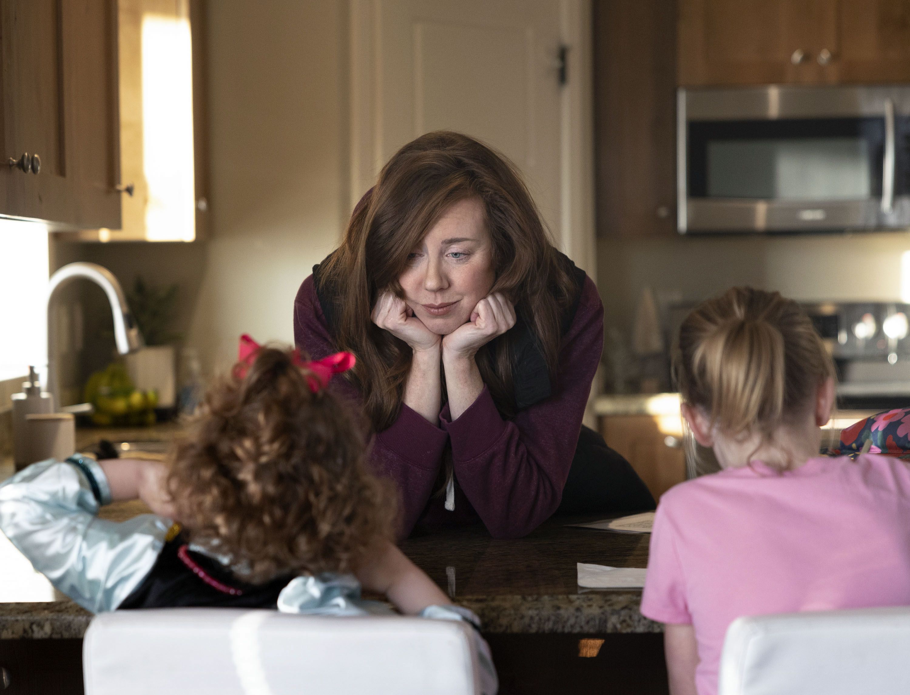 Shay Baker speaks with her daughters at their Layton home on Wednesday.