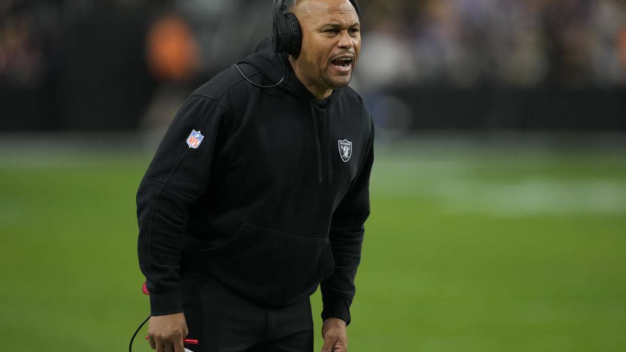 Las Vegas Raiders interim head coach Antonio Pierce makes a call during the first half of an NFL football game against the Minnesota Vikings, Sunday, Dec. 10, 2023, in Las Vegas.