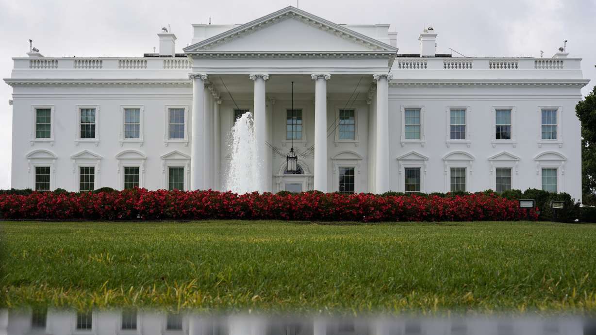 The White House is seen reflected in a puddle, Sept. 3, 2022, in Washington. 2024 will build up to the presidential election in November. Here's what to watch for in the coming year.