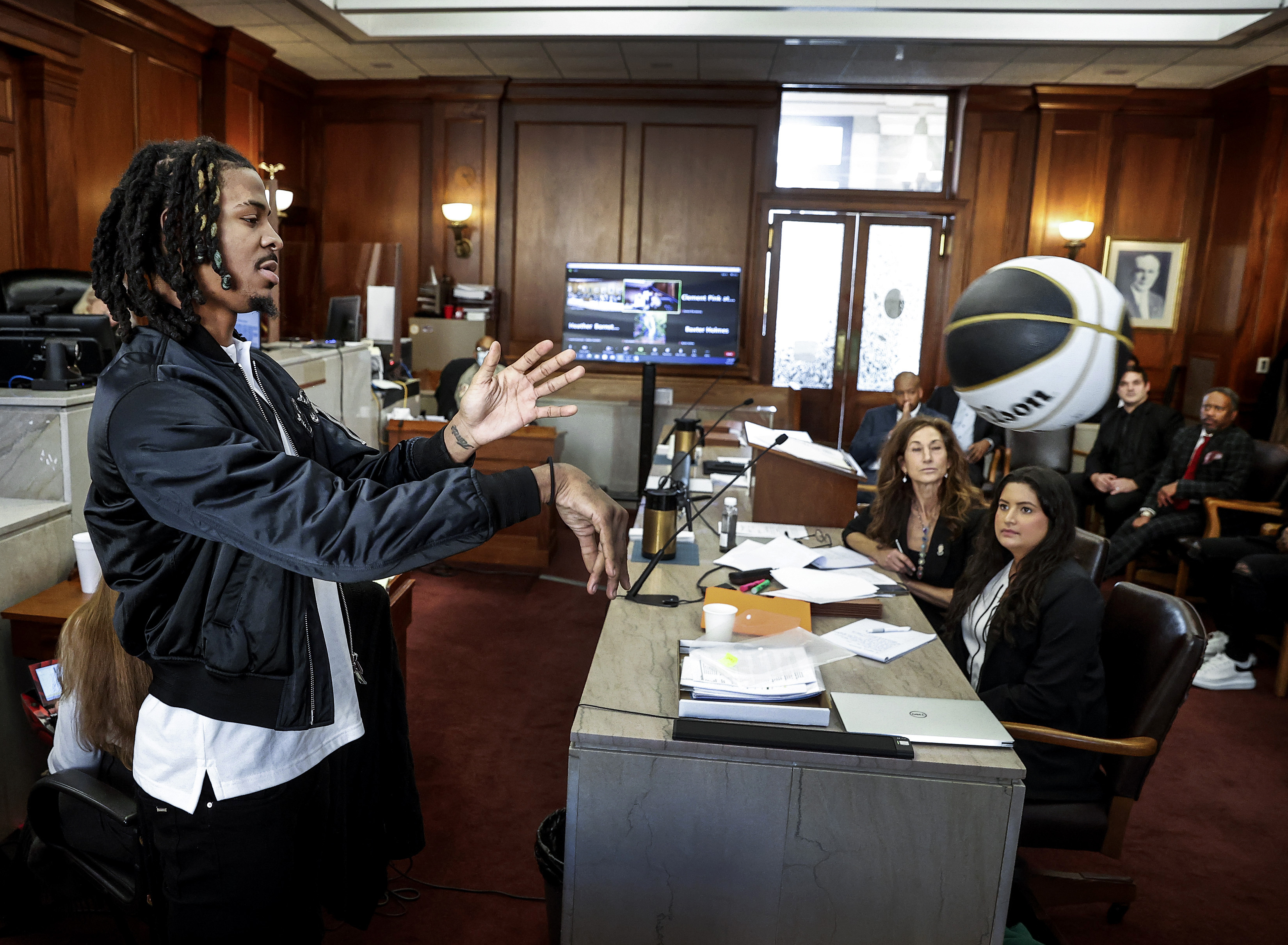 Memphis Grizzlies player Ja Morant, demonstrates a chest pass, while testifying in Judge Carol Chumney's courtroom at Shelby County Circuit Court on Monday, Dec. 11, 2023, in Memphis, Tenn. The hearing is to determine whether Morant used self defense during a fight last summer at his home. 