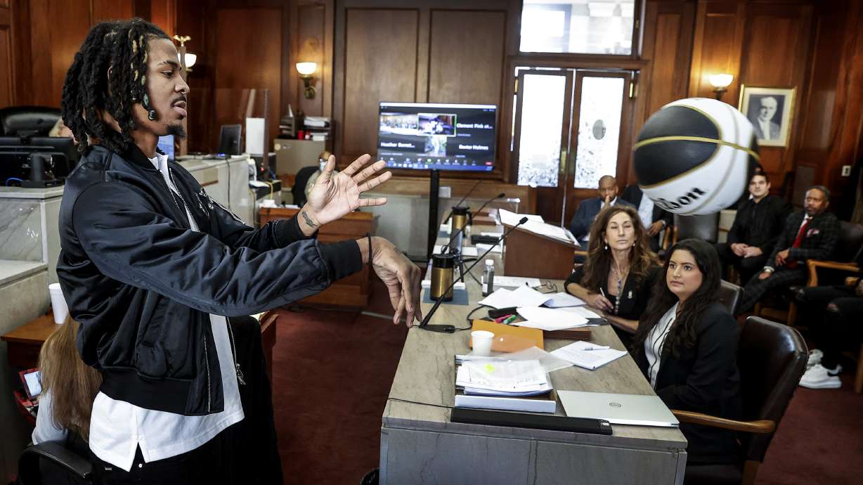 Memphis Grizzlies player Ja Morant, demonstrates a chest pass, while testifying in Judge Carol Chumney's courtroom at Shelby County Circuit Court on Monday, Dec. 11, 2023, in Memphis, Tenn. The hearing is to determine whether Morant used self defense during a fight last summer at his home.