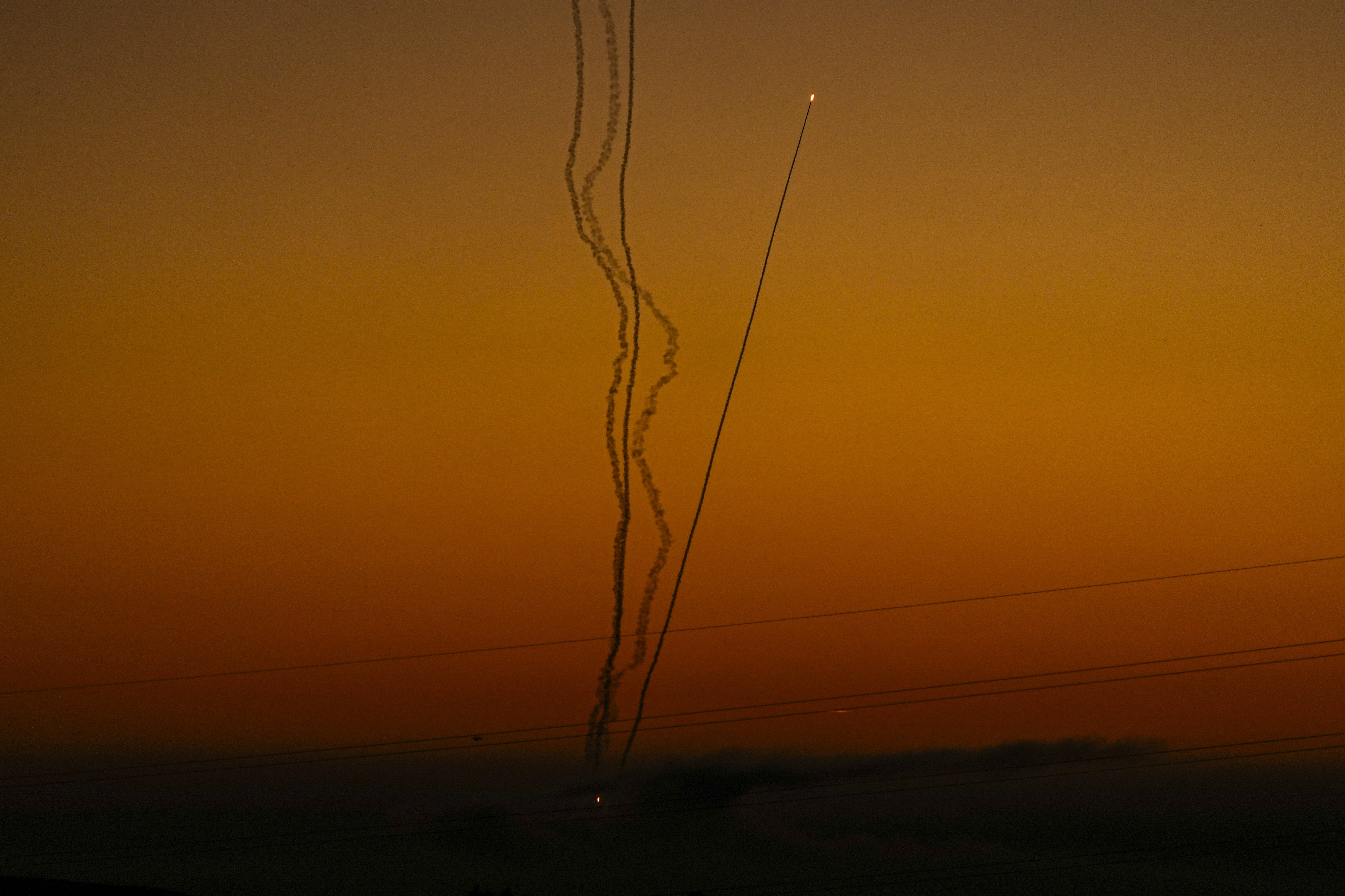 Rockets are fired toward Israel from the Gaza Strip, as seen from southern Israel, Friday.