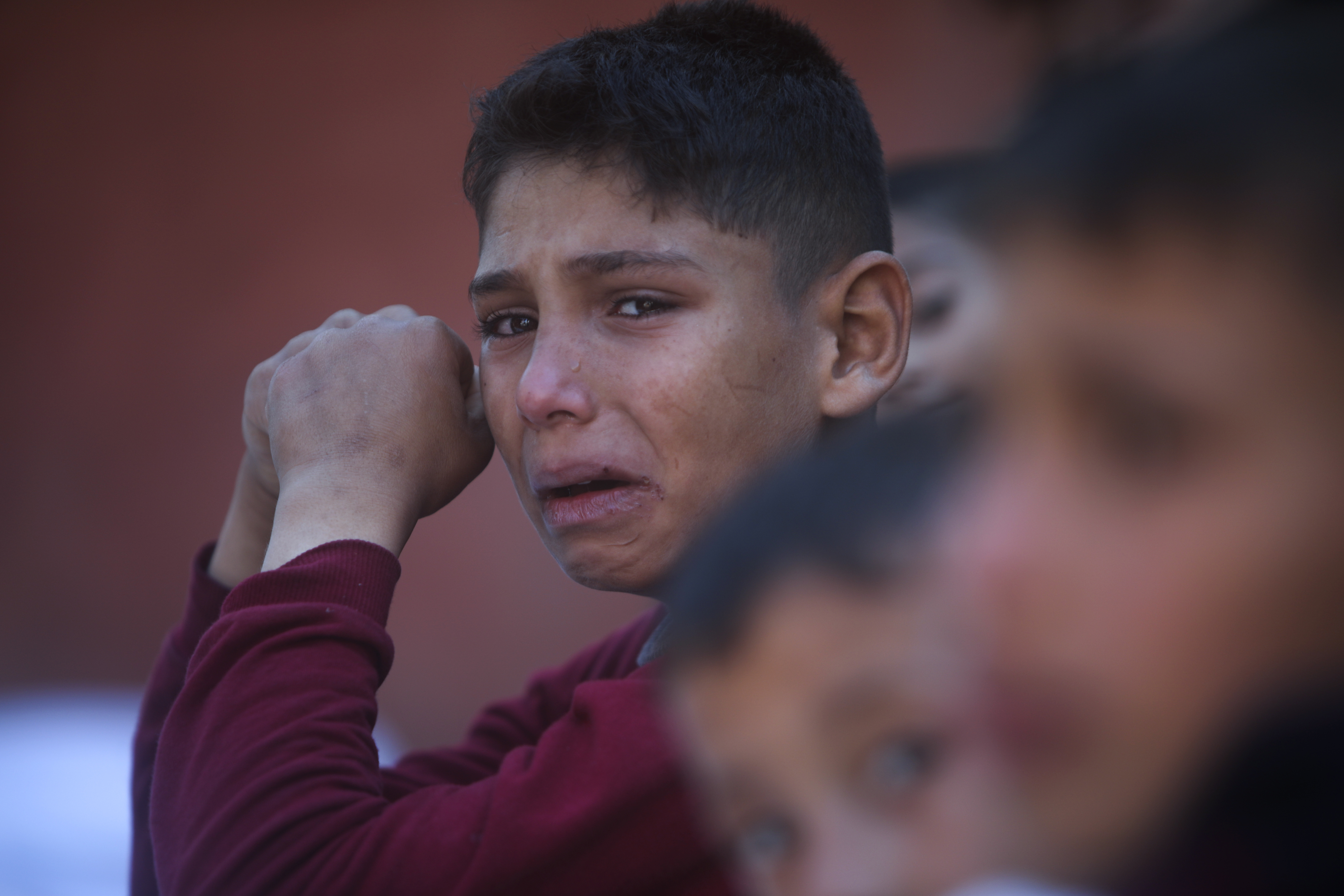 A Palestinian boy cries for his relatives who were killed in the Israeli bombardment of the Gaza Strip, at Nasser hospital in Khan Younis, Friday.