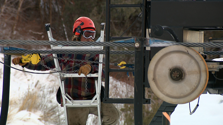 Utah ski resorts need snow or cold temperatures to make snow. Here a worker checks a lift at Cherry Peak in Cache County on Thursday.