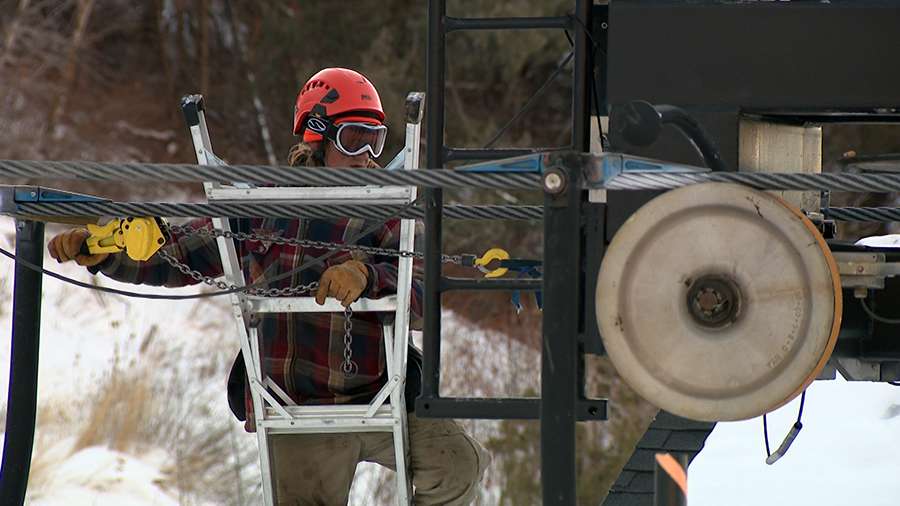 Utah ski resorts need snow or cold temperatures to make snow. Here a worker checks a lift at Cherry Peak in Cache County on Thursday.