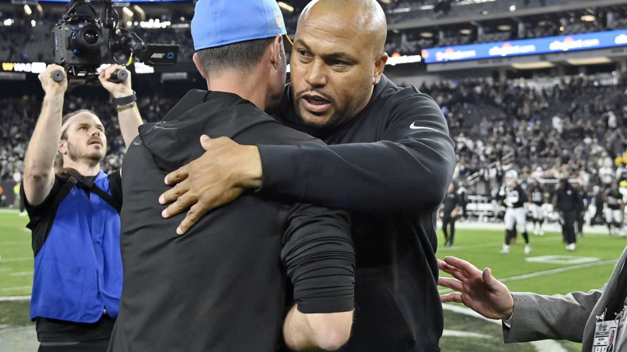 Los Angeles Chargers head coach Brandon Staley, left, embraces Las Vegas Raiders interim head coach Antonio Pierce after an NFL football game, Thursday, Dec. 14, 2023, in Las Vegas.
