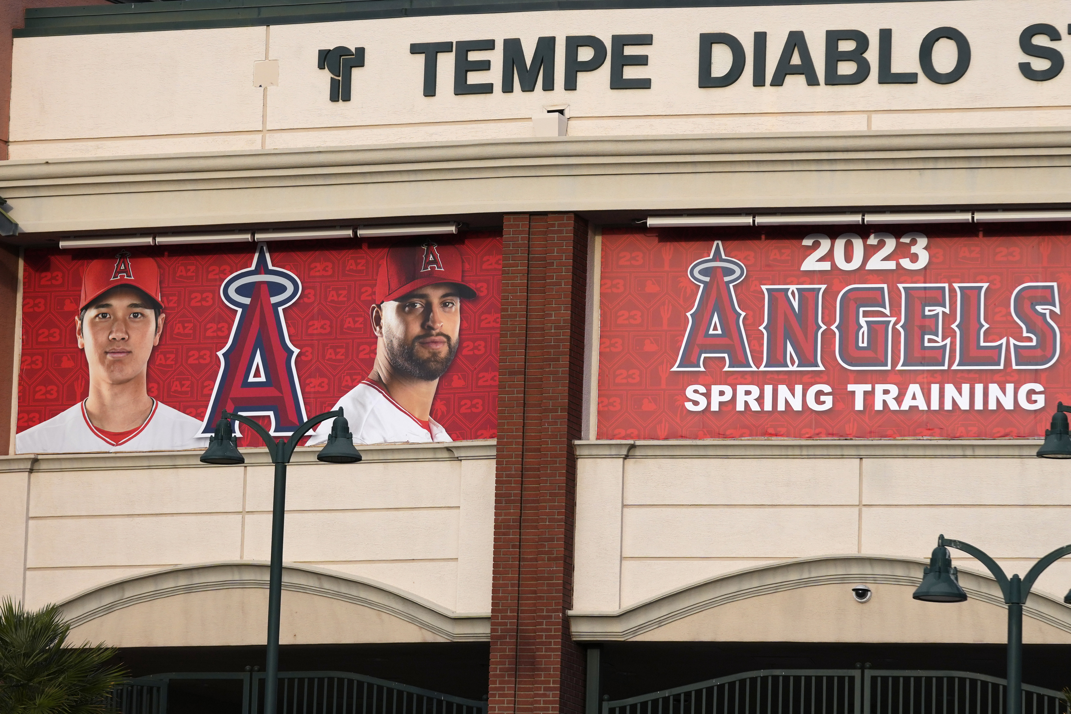 After the Los Angeles Dodgers signing of former Los Angeles Angels player Shohei Ohtani, left, his image still adorns the Angels' Tempe Diablo Stadium, sharing the prominent spot with pitcher Patrick Sandoval at the spring training home of the Angels, Monday, Dec. 11, 2023, in Tempe, Ariz. The Angels have already removed the Ohtani photo banner at the Angels regular season stadium. 