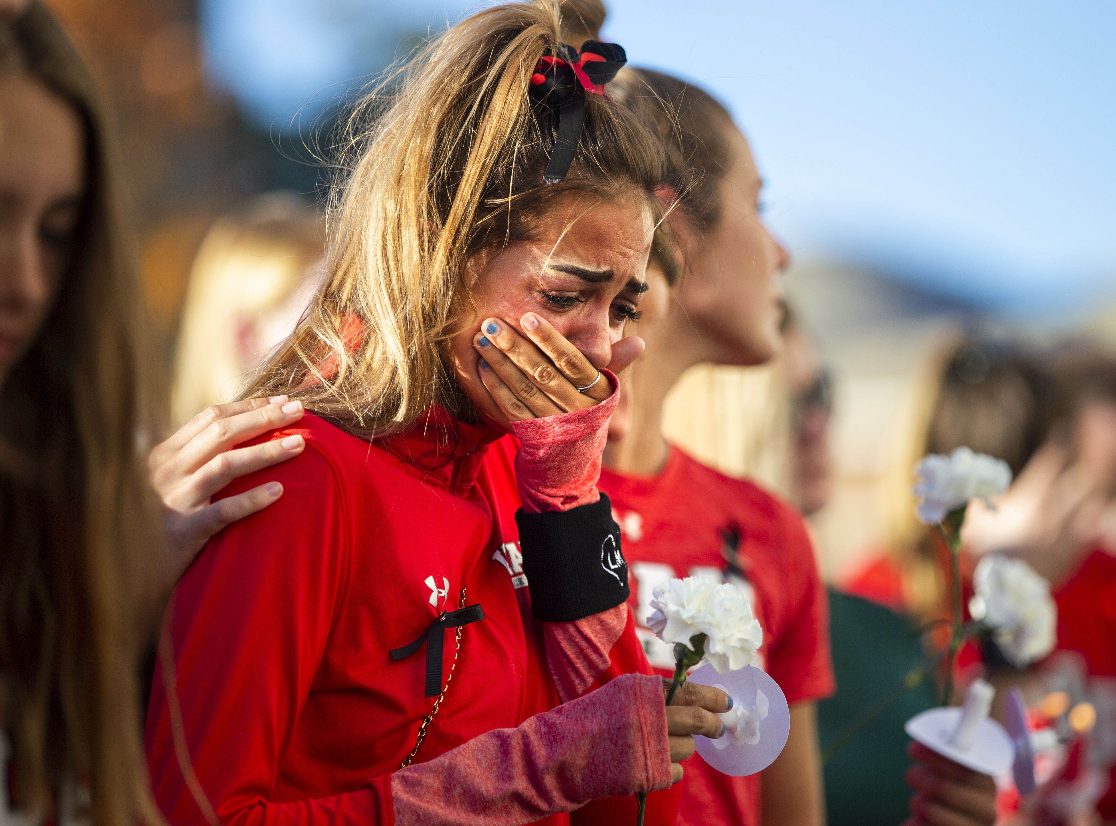 A member of the University of Utah track team reacts during a vigil for Lauren McCluskey at the Park Building on Oct. 24, 2018. McCluskey was shot on campus by a former boyfriend.