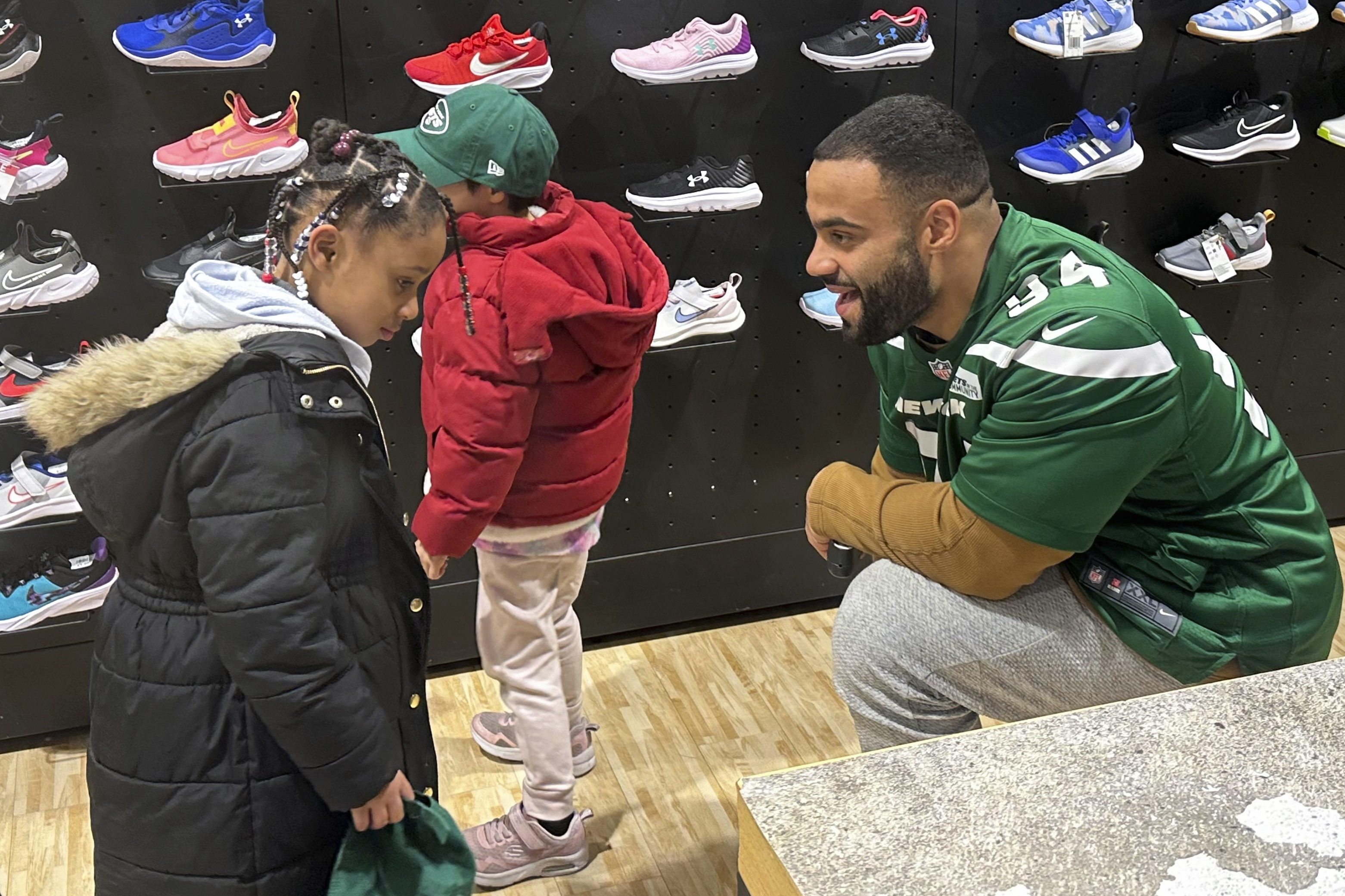 New York Jets defensive lineman Solomon Thomas chats with a student from Brooklyn Community Services Jets' Academy during a holiday shopping spree hosted by the team at Dick's Sporting Goods in East Hanover, N.J., on Tuesday, Dec. 12, 2023. 