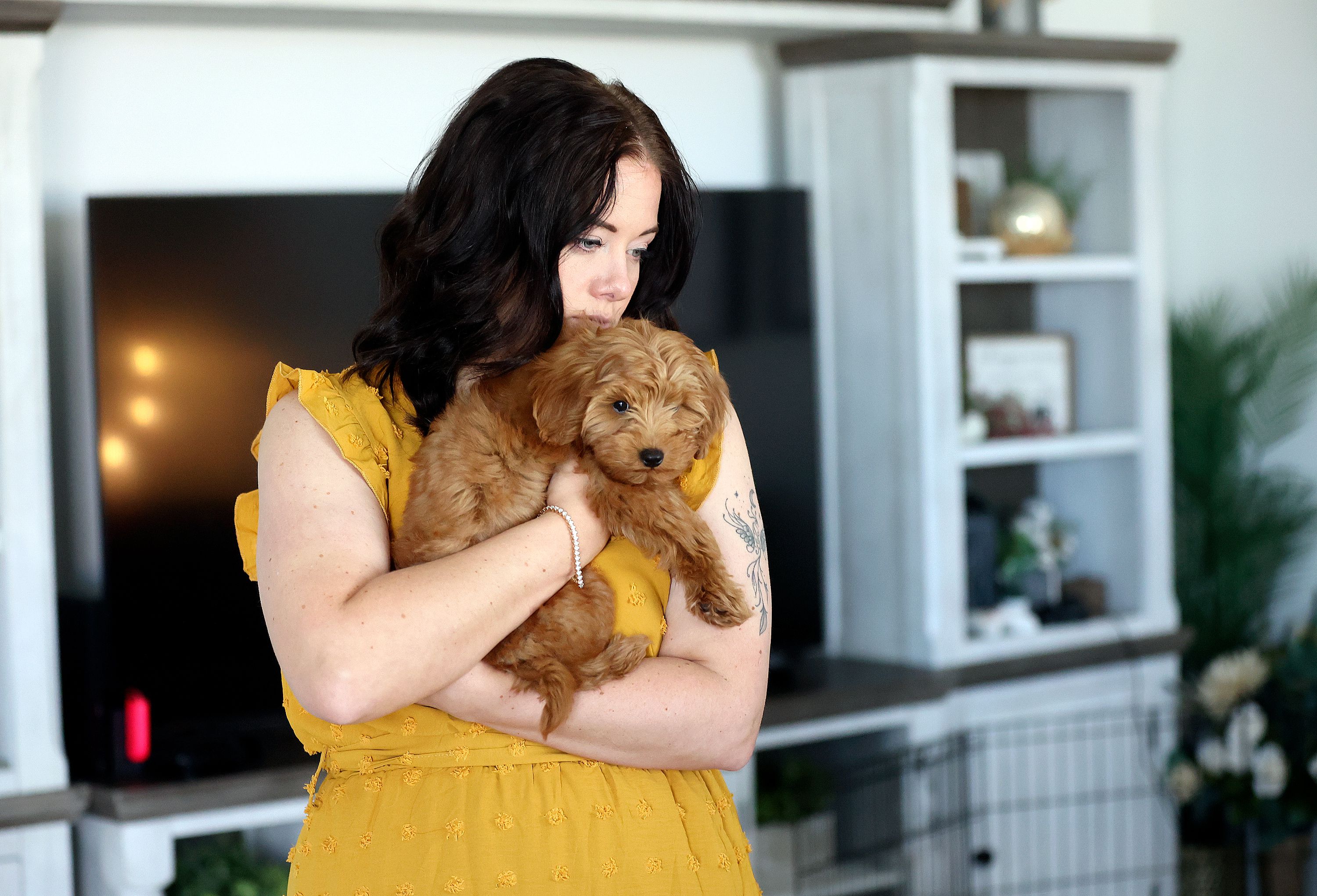 Lyndsey holds her dog Bodie as she takes a break from an interview about surviving domestic violence in her previous relationship at her home in Santaquin on Oct. 24.