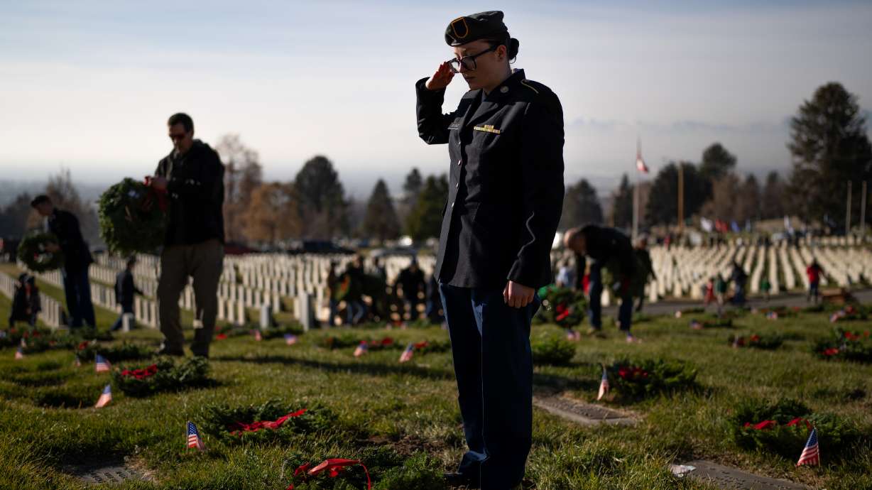 Athena Wygant, 18, and a member of the Herriman High School JROTC, salutes after laying wreaths on veterans’ graves as part of the Wreaths Across America program at the Salt Lake City Cemetery in Salt Lake City on Saturday.
