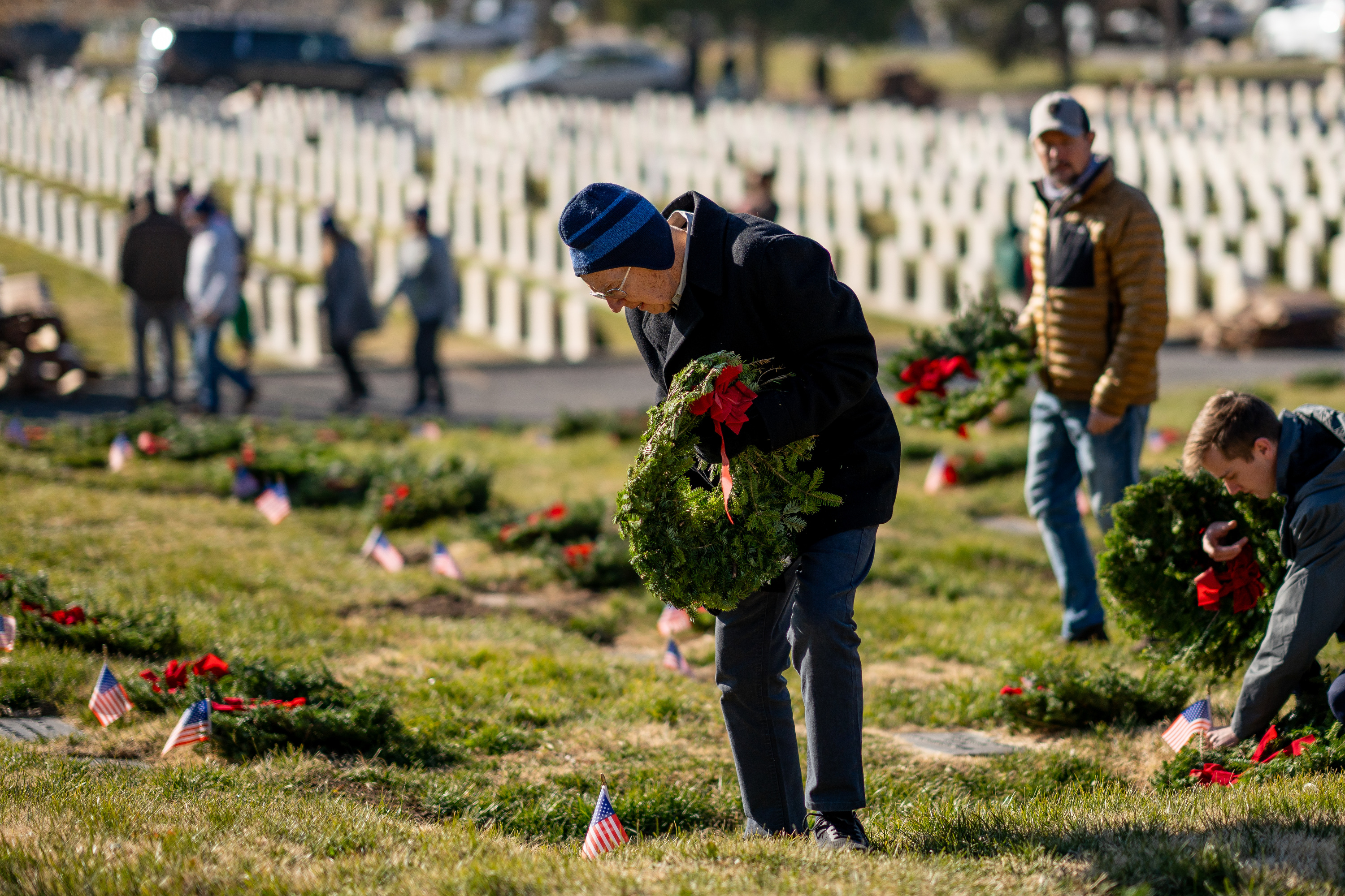 Ralph Gochnour, 89, lays wreaths on veterans’ graves as part of the Wreaths Across America program at the Salt Lake City Cemetery in Salt Lake City on Saturday.
