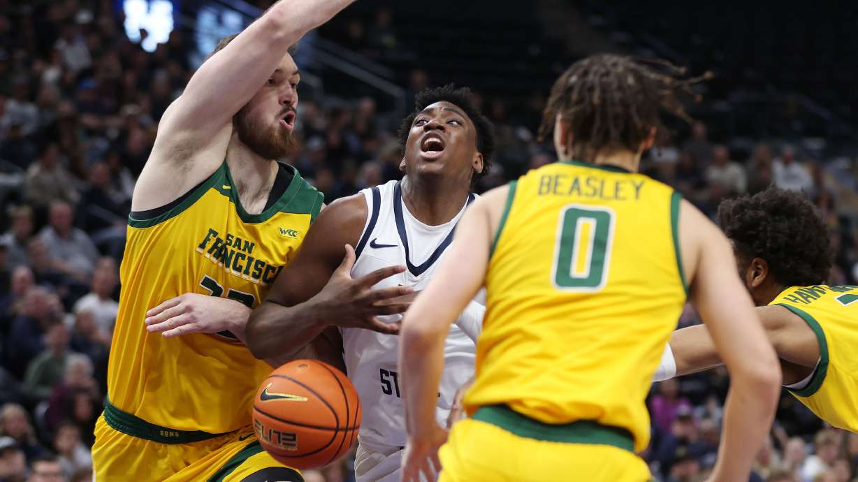 Utah State Aggies forward Great Osobor (1) is defended by San Francisco Dons forward Junjie Wang (35) at the Delta Center in Salt Lake City on Saturday, Dec. 16, 2023.