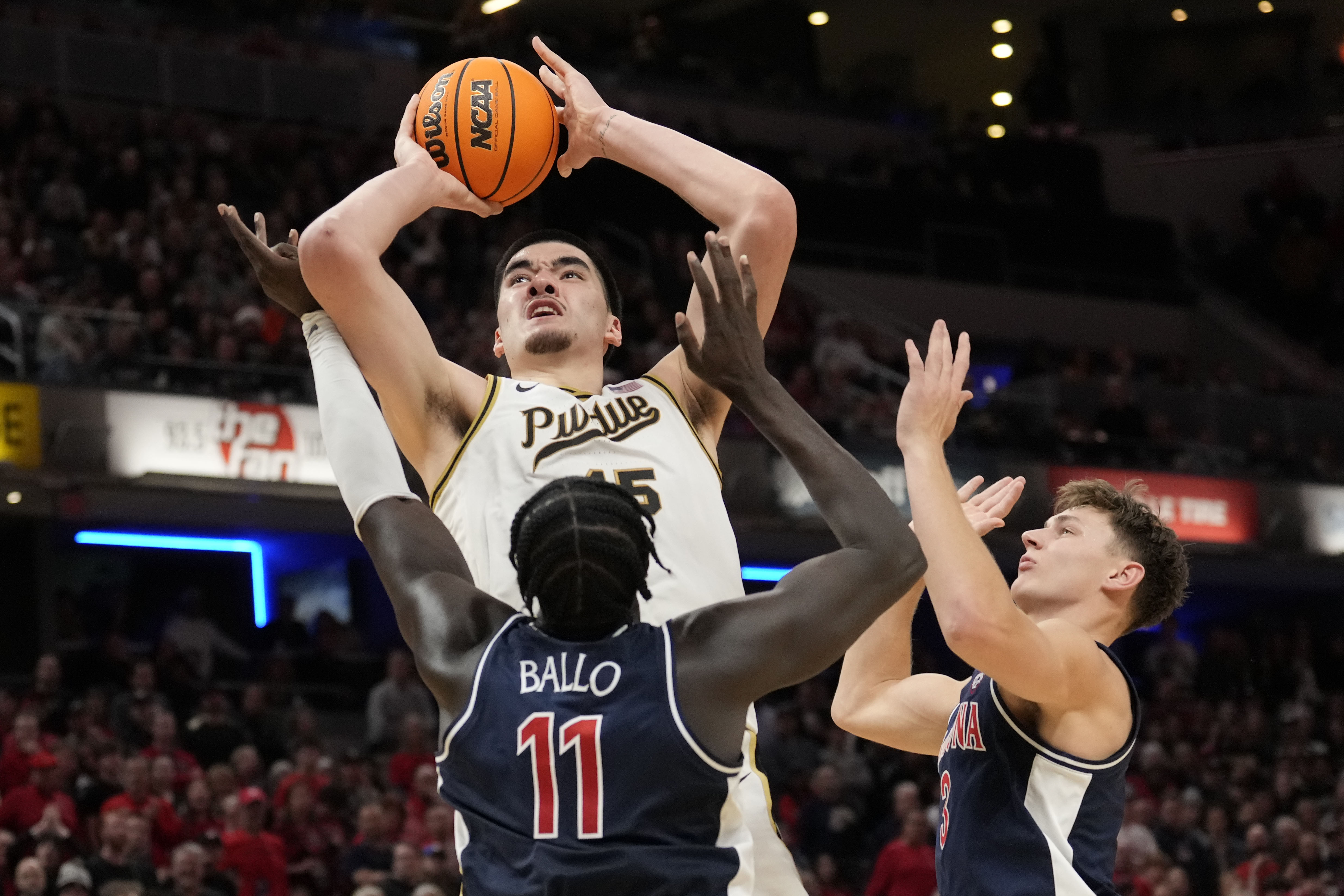 Purdue center Zach Edey (15) shoots over Arizona center Oumar Ballo (11) in the second half of an NCAA college basketball game in Indianapolis, Saturday, Dec. 16, 2023. 