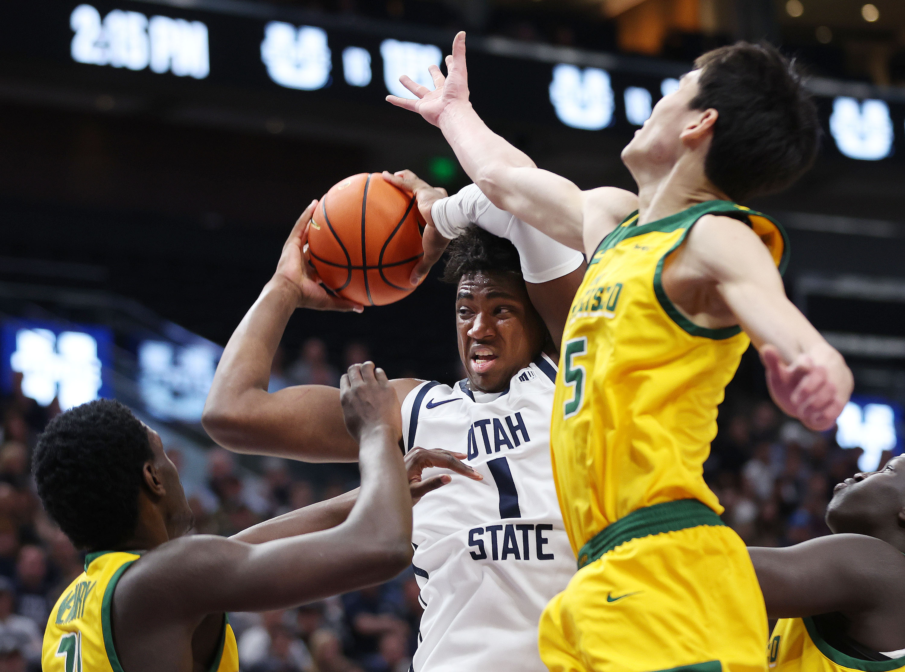 Utah State Aggies forward Kalifa Sakho (34) drives on San Francisco Dons guard Mike Sharavjamts (5)  at the Delta Center in Salt Lake City on Saturday, Dec. 16, 2023.