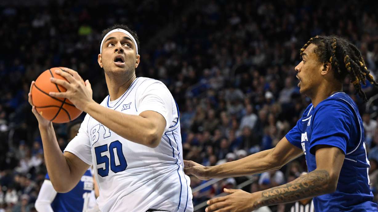 Brigham Young center Aly Khalifa (50) spins toward the basket with Georgia State guard Lucas Taylor (31) defending as BYU and Georgia State play at the Marriott Center in Provo on Saturday, Dec. 16, 2023. BYU won 86-54.