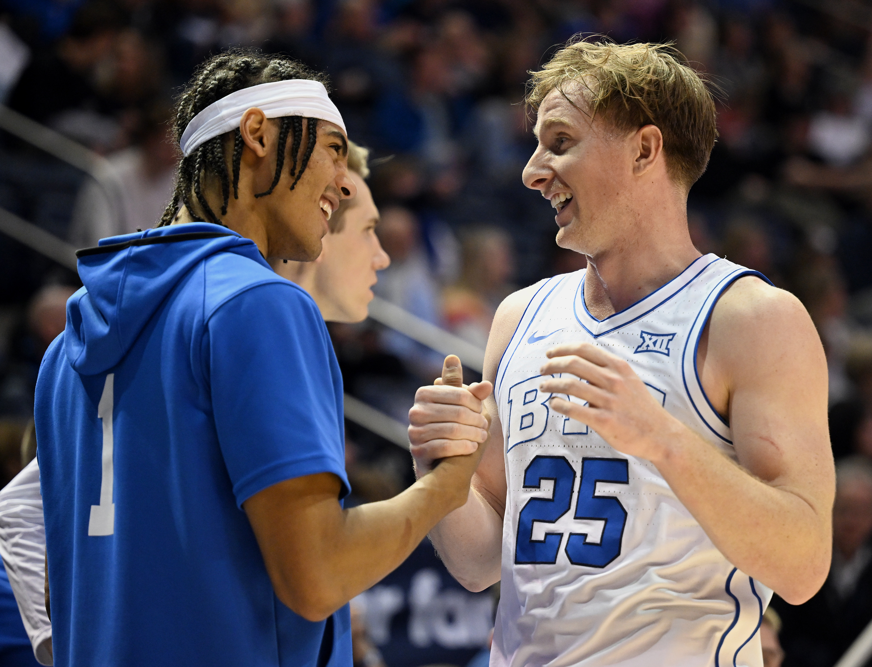 Brigham Young guard Trey Stewart (1) congratulates Brigham Young guard Dawson Baker (25) as he comes out of the game as BYU and Georgia State play at the Marriott Center in Provo on Saturday, Dec. 16, 2023. BYU won 86-54.