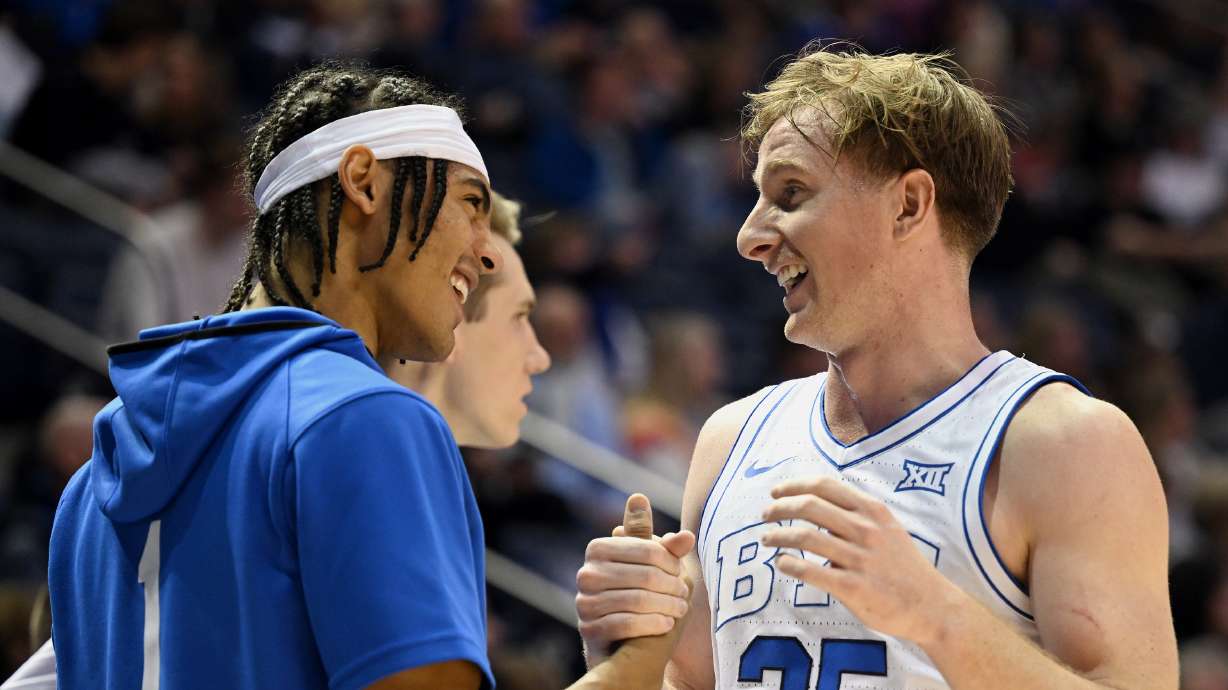 Brigham Young guard Trey Stewart (1) congratulates Brigham Young guard Dawson Baker (25) as he comes out of the game as BYU and Georgia State play at the Marriott Center in Provo on Saturday, Dec. 16, 2023. BYU won 86-54.