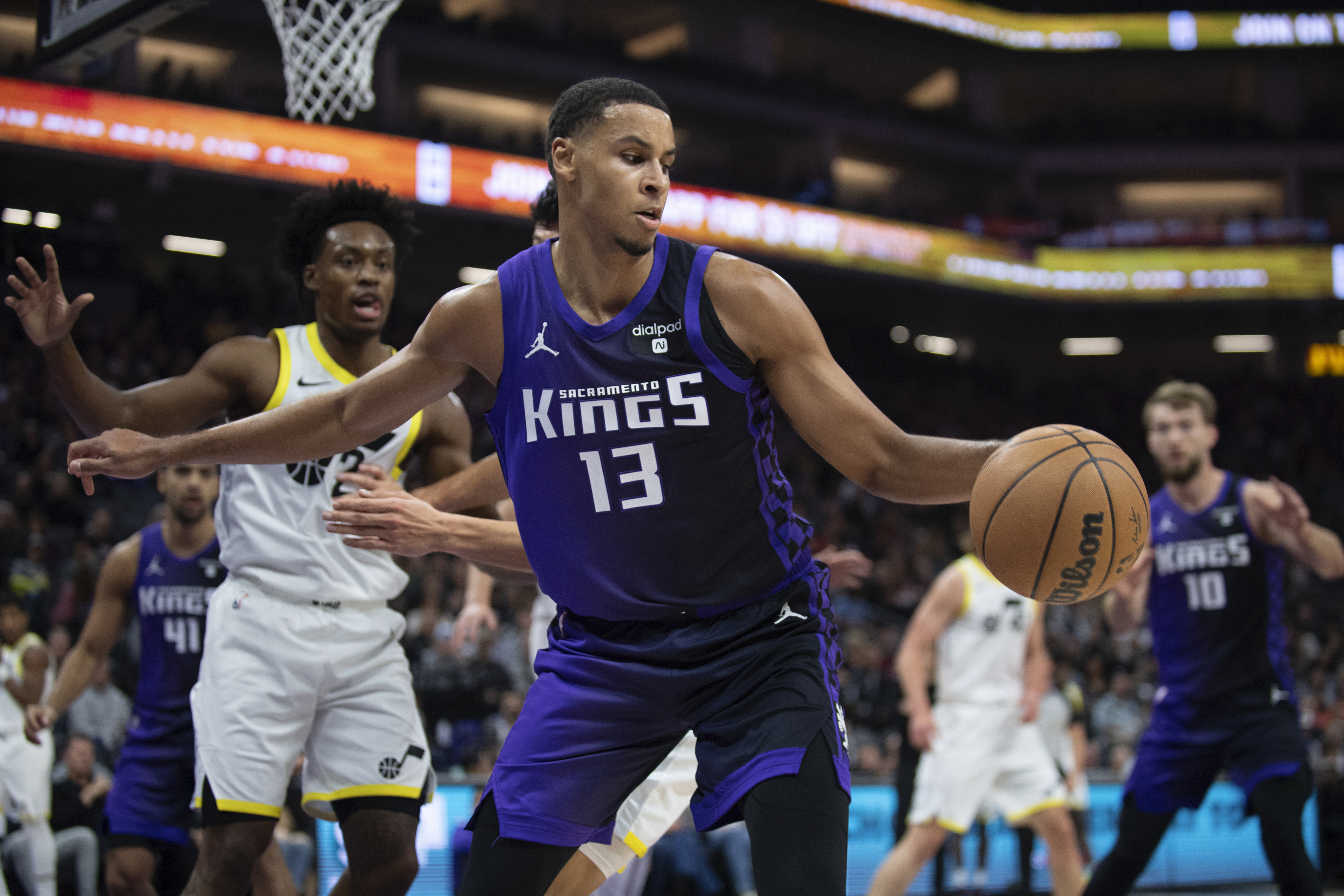 Sacramento Kings forward Keegan Murray (13) grabs a long rebound as Utah Jazz guard Collin Sexton (2) watches during the first quarter of an NBA basketball game in Sacramento, Calif., Saturday, Dec. 16, 2023.