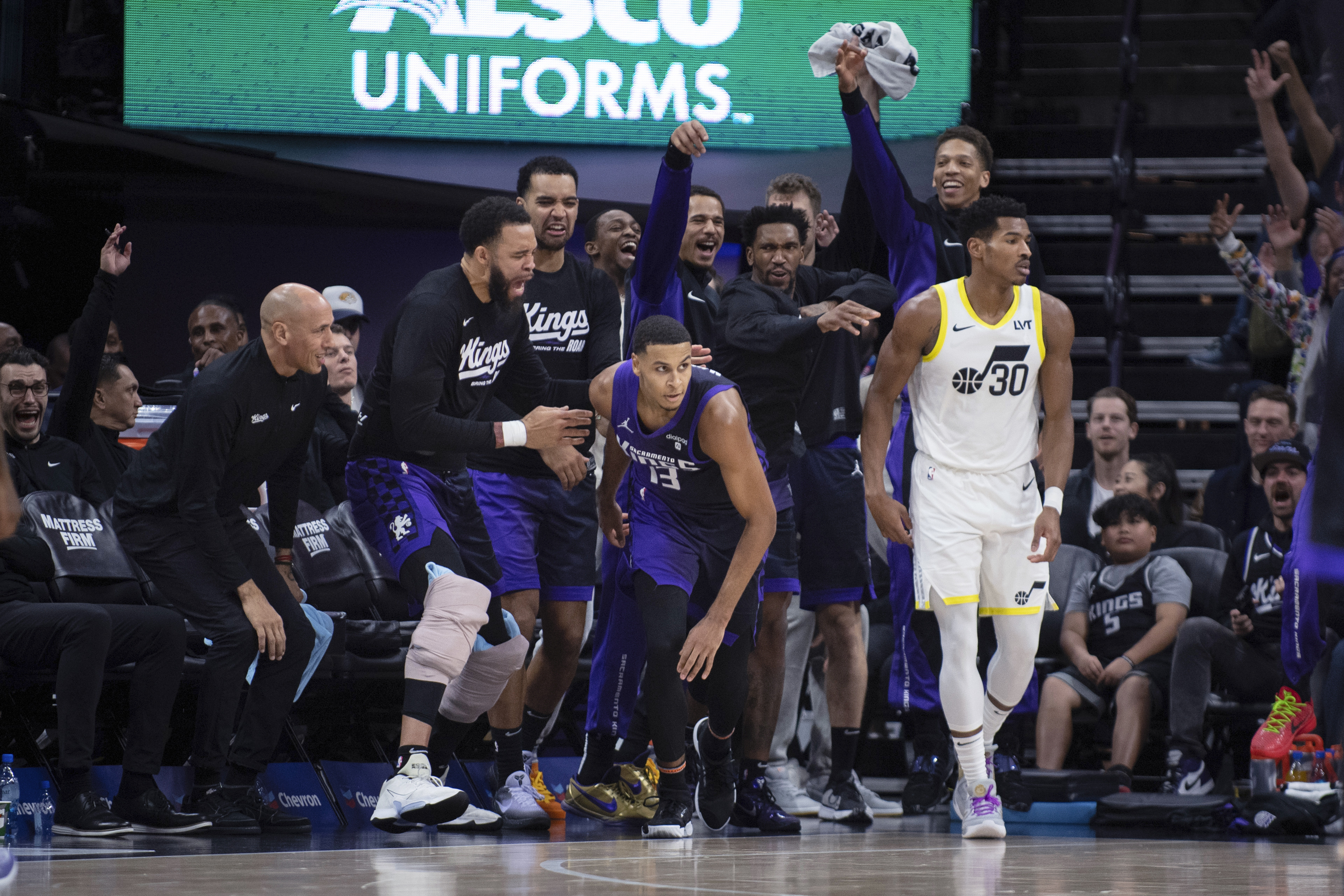 Sacramento Kings on the bench celebrate a 3-pointer by forward Keegan Murray (13) against Utah Jazz guard Ochai Agbaji (30) during the second half of an NBA basketball game in Sacramento, Calif., Saturday, Dec. 16, 2023. 