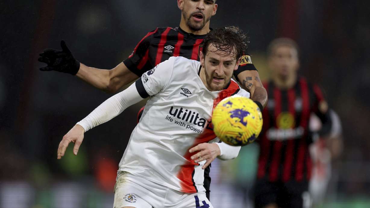 Luton Town's Tom Lockyer, front, and Bournemouth's Dominic Solanke battle for the ball during the English Premier League soccer match between Bournemouth and Luton Town at the Vitality Stadium, Bournemouth, England, Saturday Dec. 16, 2023.