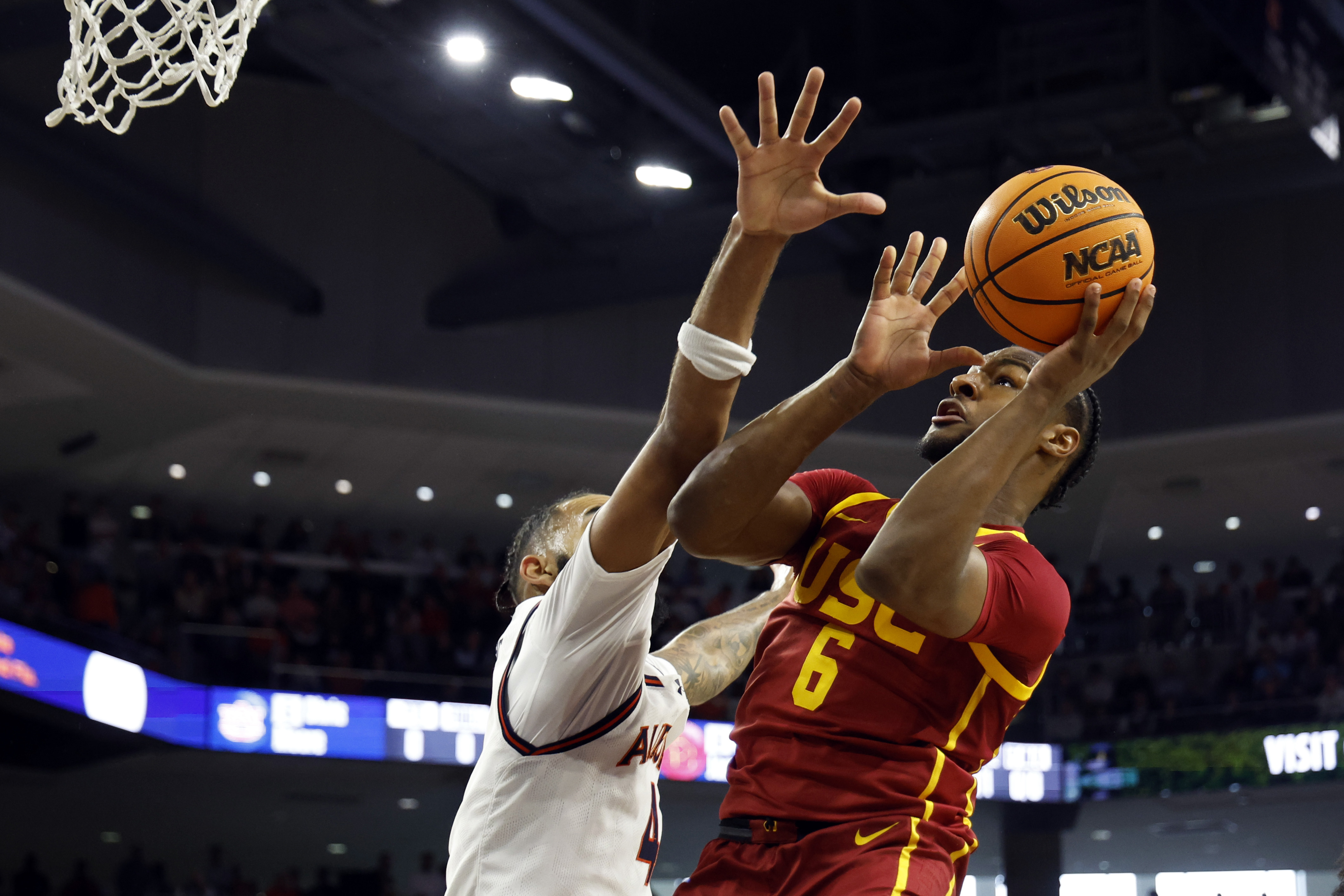 USC guard Bronny James (6) puts up a shot over Auburn forward Johni Broome (4) during the first half of an NCAA basketball game, Sunday, Dec. 17, 2023, in Auburn, Ala. 