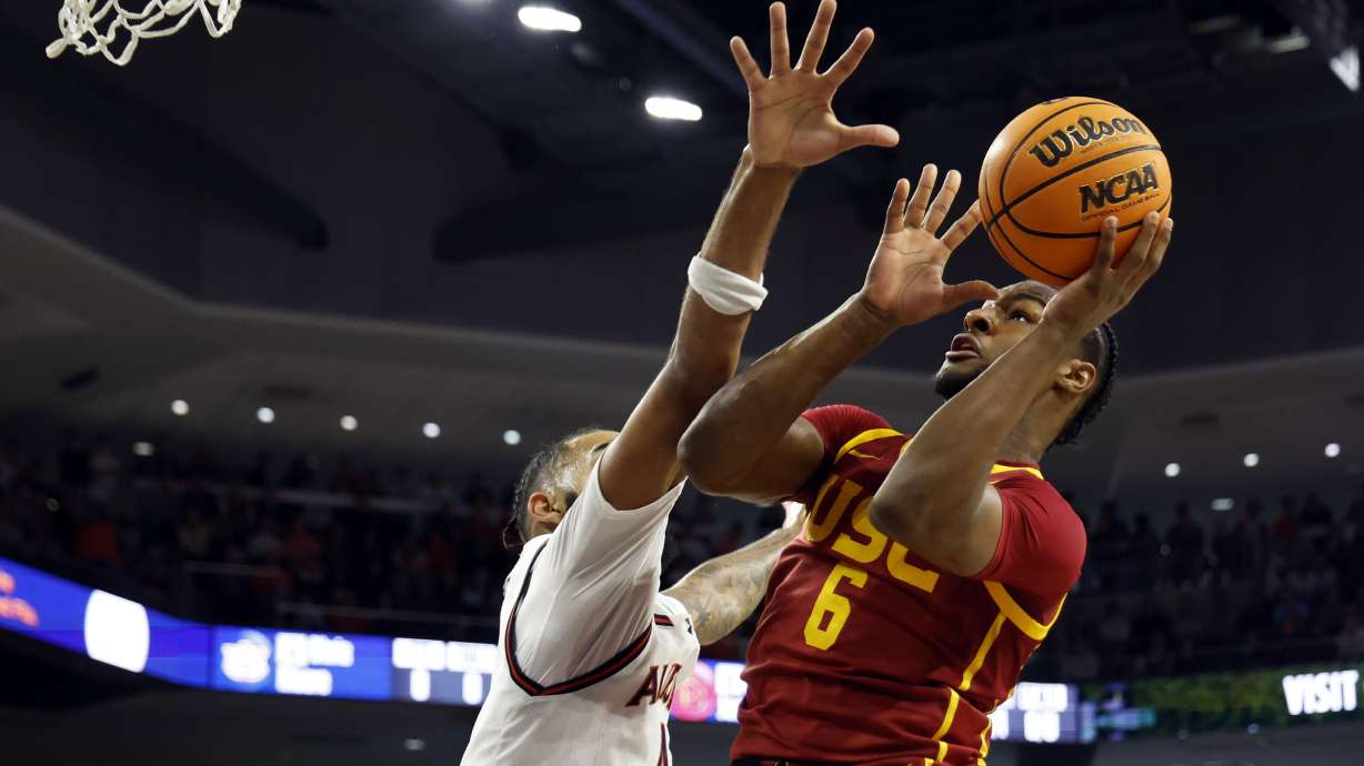 USC guard Bronny James (6) puts up a shot over Auburn forward Johni Broome (4) during the first half of an NCAA basketball game, Sunday, Dec. 17, 2023, in Auburn, Ala.