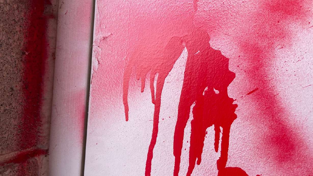 A close-up photo of red spray paint written on a Salt Lake City elementary school Sunday morning. Police are investigating vandalism found on the wall at Bonneville Elementary School as a potential hate crime.