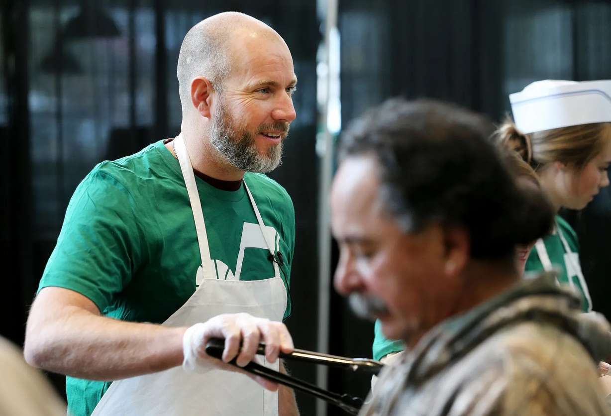 Steve Miller joins with other members of the Miller family, Larry H. Miller Sports & Entertainment employees and select Salt Lake City Stars players to serve food at the 19th annual “We Care — We Share” Thanksgiving Dinner for local homeless and low-income individuals at Vivint Arena on Nov. 20, 2017.