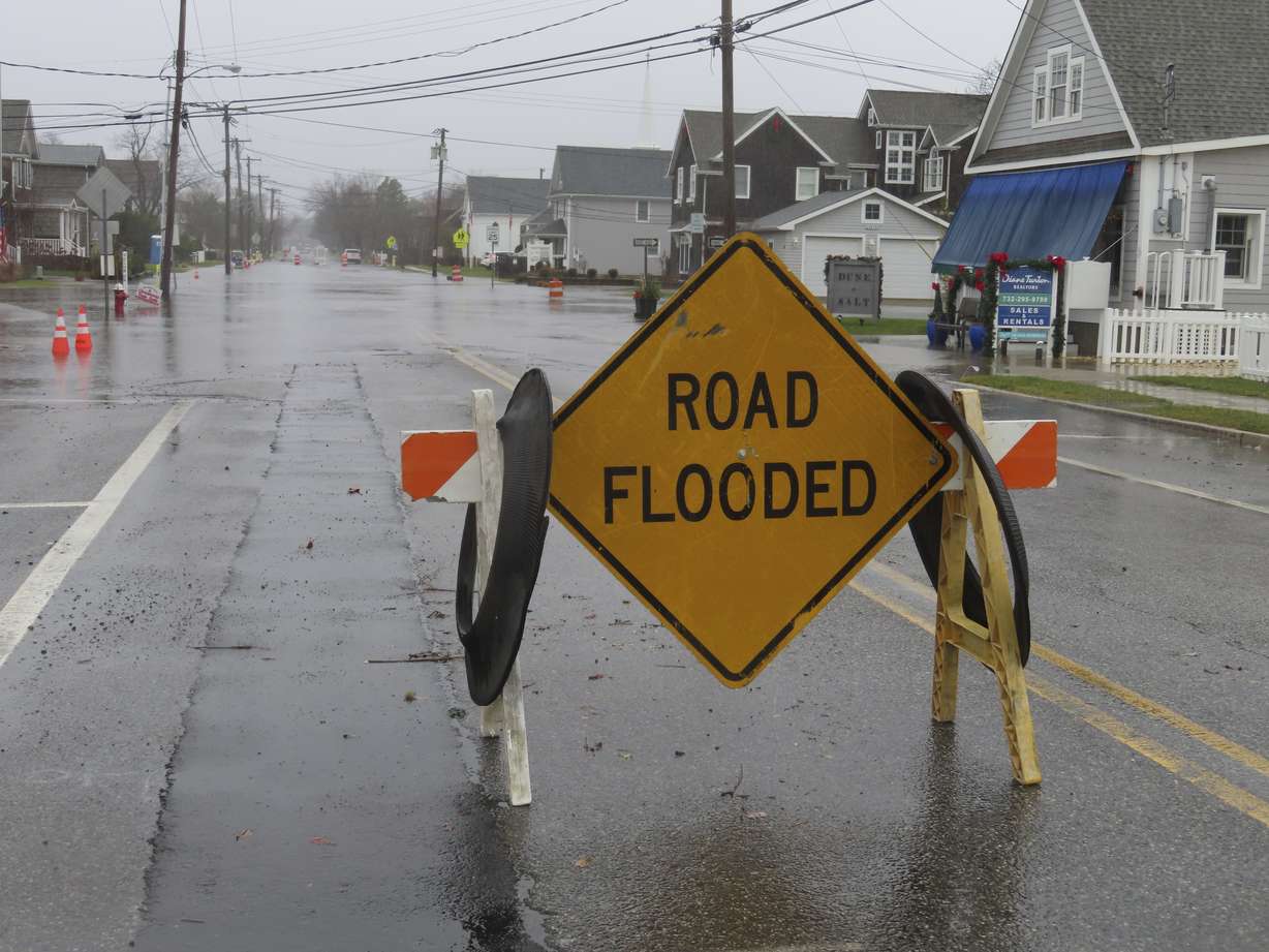 A barrier warns of flooding in Bay Head, N.J., during a storm on Monday. Communities up and down the East Cast were dealing with flooding and high winds from the storm.