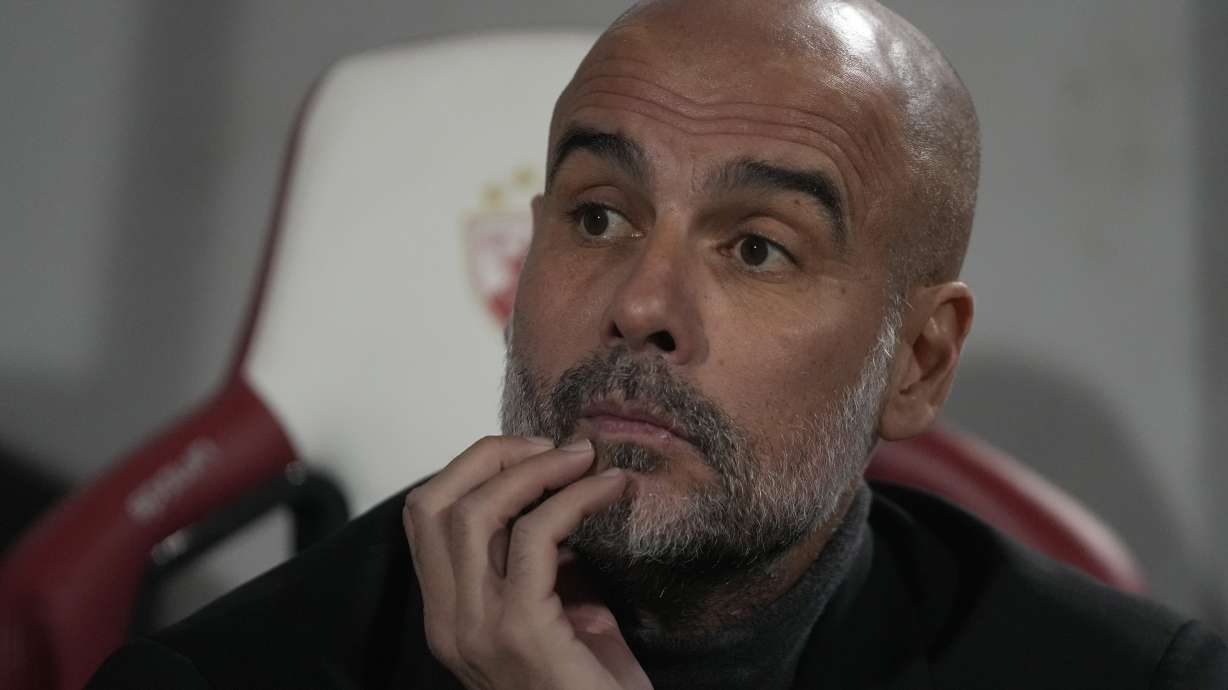 Manchester City's head coach Pep Guardiola waits for the start of the Group G Champions League soccer match between Red Star and Manchester City, at the Rajko Mitic Stadium in Belgrade, Serbia, Wednesday, Dec. 13, 2023.