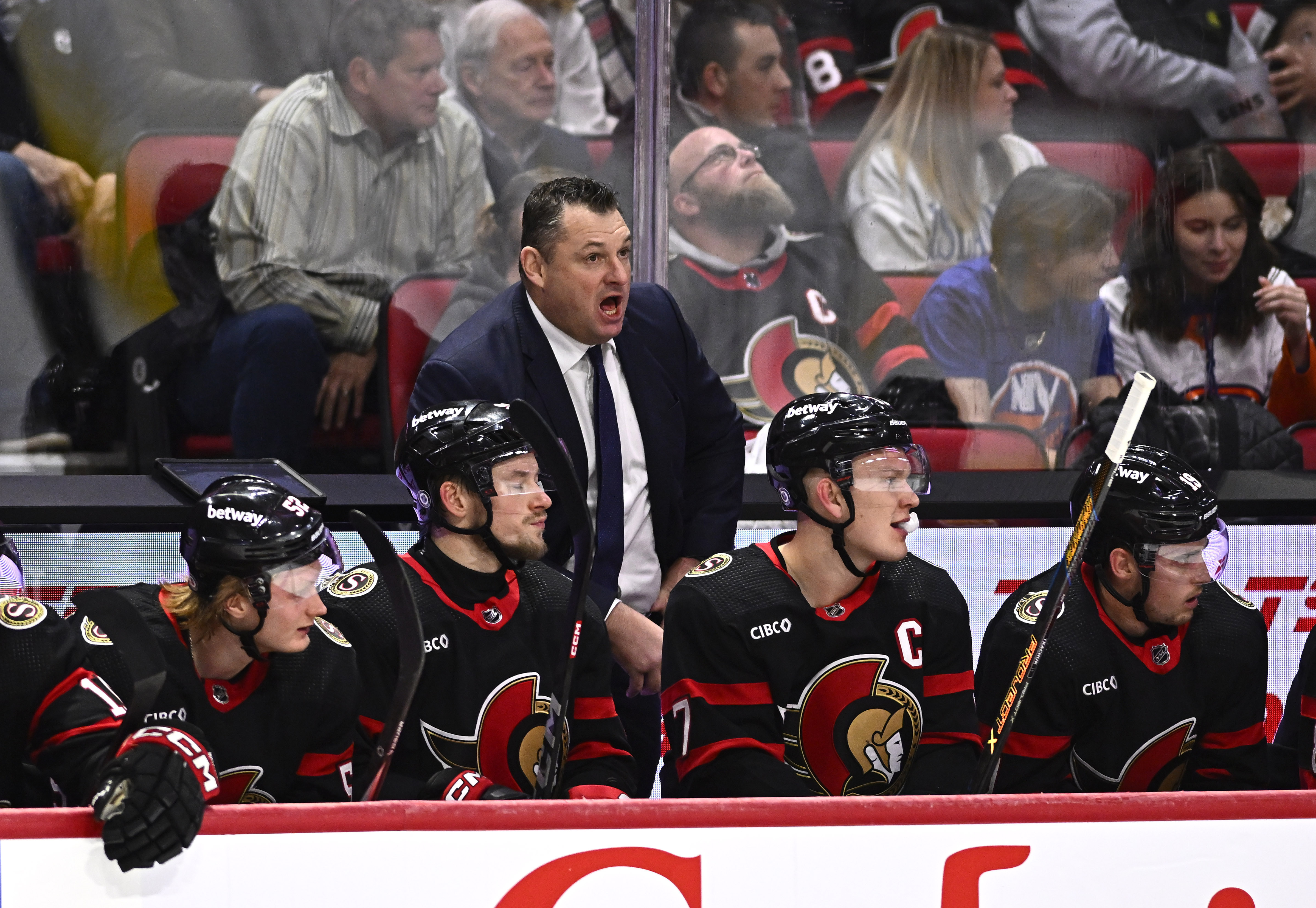 Ottawa Senators head coach D.J. Smith, center, stands behind the bench during first-period NHL hockey game action against the New York Islanders in Ottawa, Ontario, Friday, Nov. 24, 2023. 