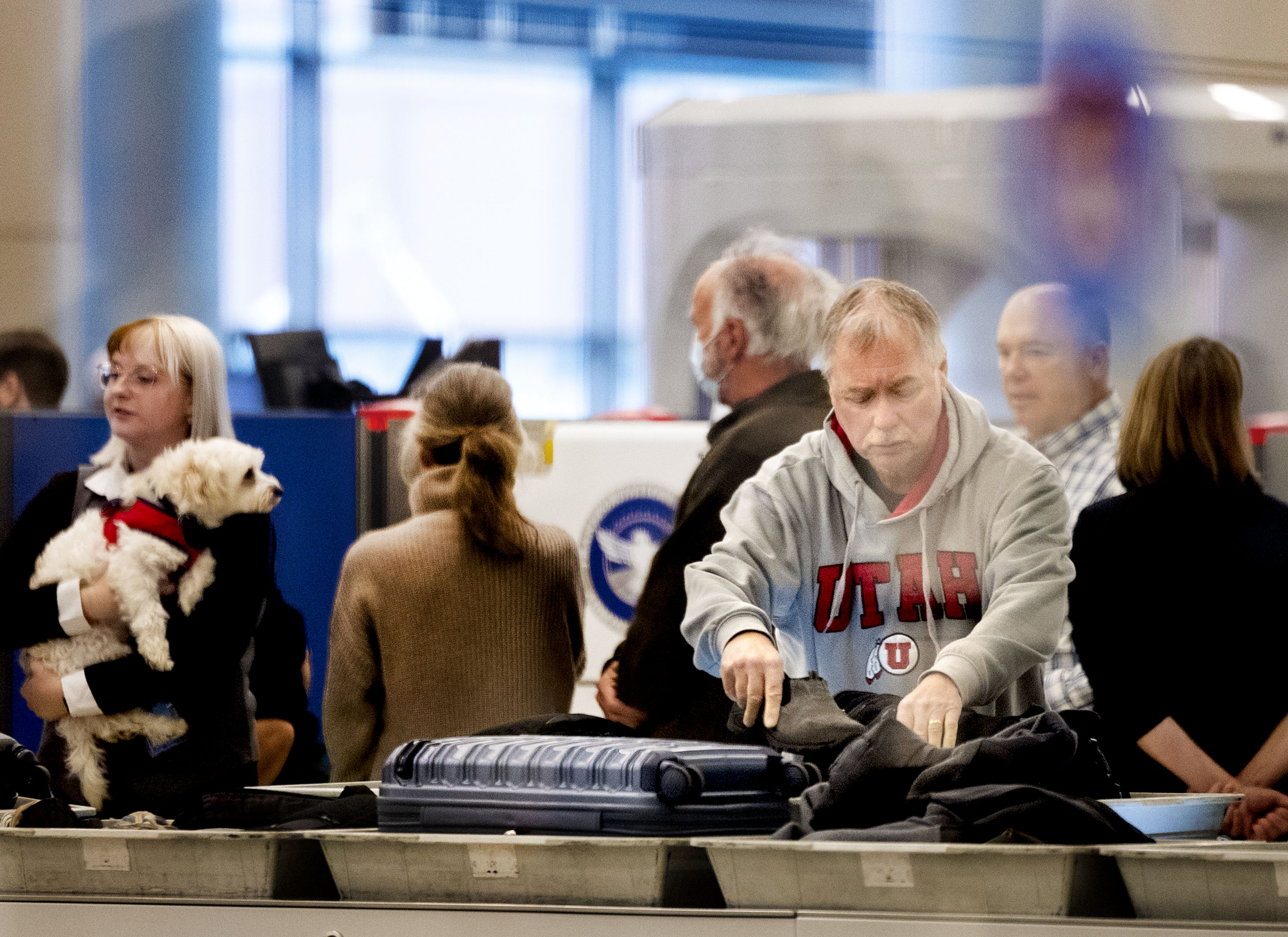 Travelers go through security at Salt Lake City International Airport on Monday. More than 425,000 people are expected to fly out of Salt Lake City International Airport in the coming weeks as a part of a busy holiday travel period.