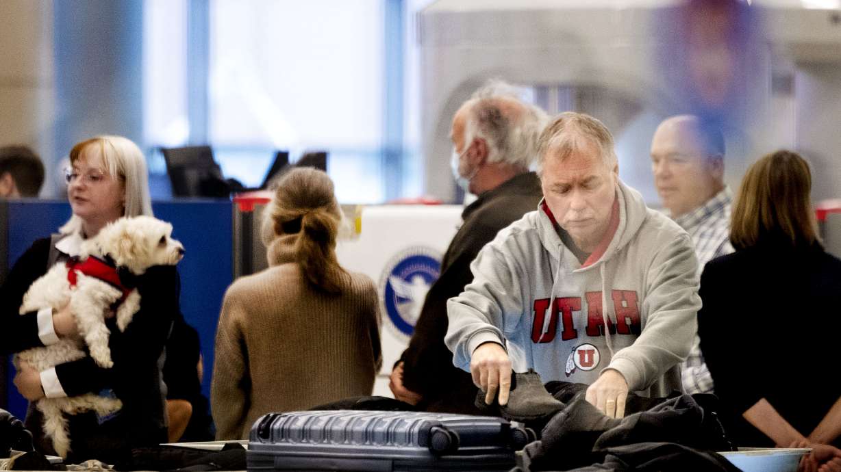 Travelers go through security at Salt Lake City International Airport on Monday. More than 425,000 people are expected to fly out of Salt Lake City International Airport in the coming weeks as a part of a busy holiday travel period.