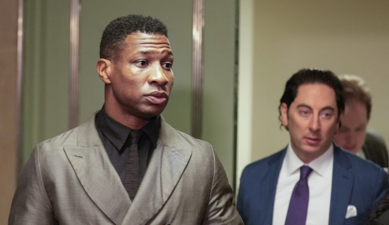 Jonathan Majors, left, enters a courtroom at the Manhattan criminal courts in New York, Monday. The actor was convicted of assaulting his then-girlfriend as the two struggled over a phone in the back seat of a chauffeured car. 